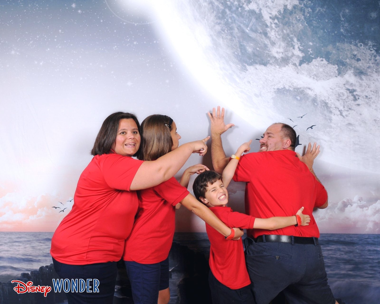 All four of us against the painted waves backdrop
