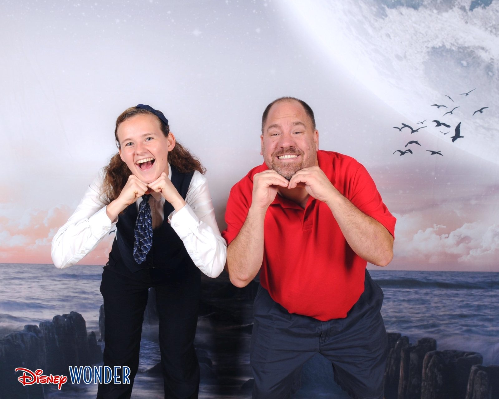 Lisa and Michael making heart hands for the camera