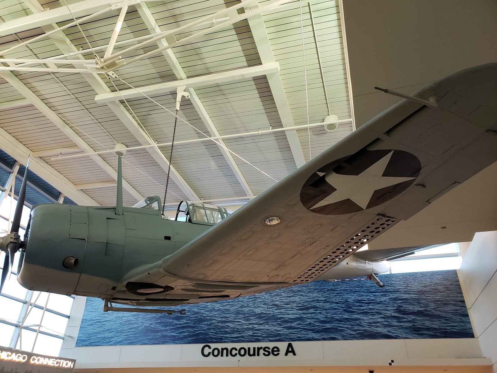 A vintage plane hangs over Concourse A