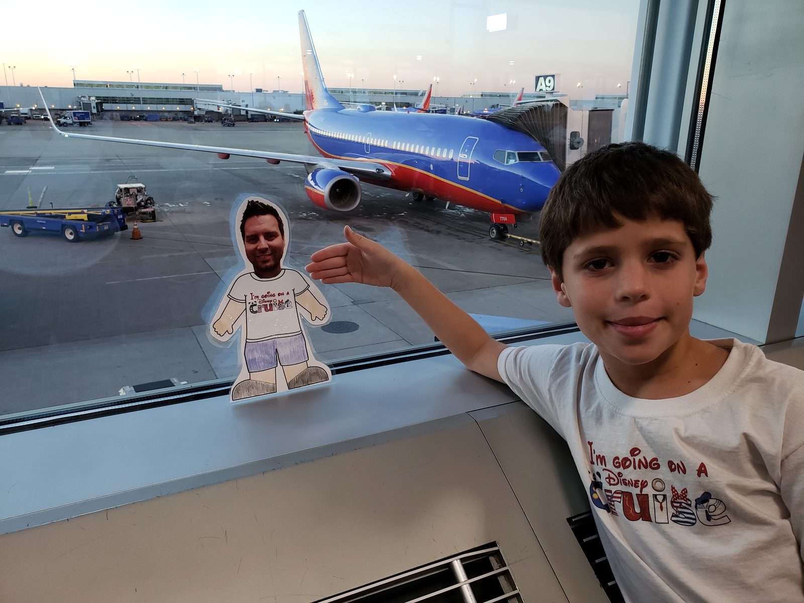 Thomas with our paper travel buddy at the gate
