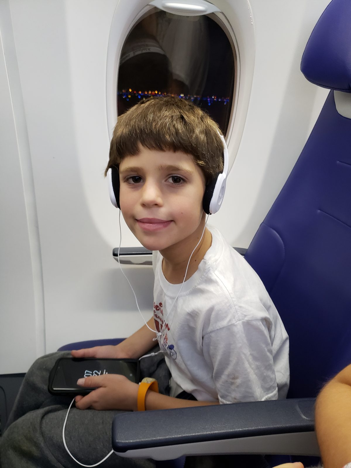Thomas with his headphones on for the flight