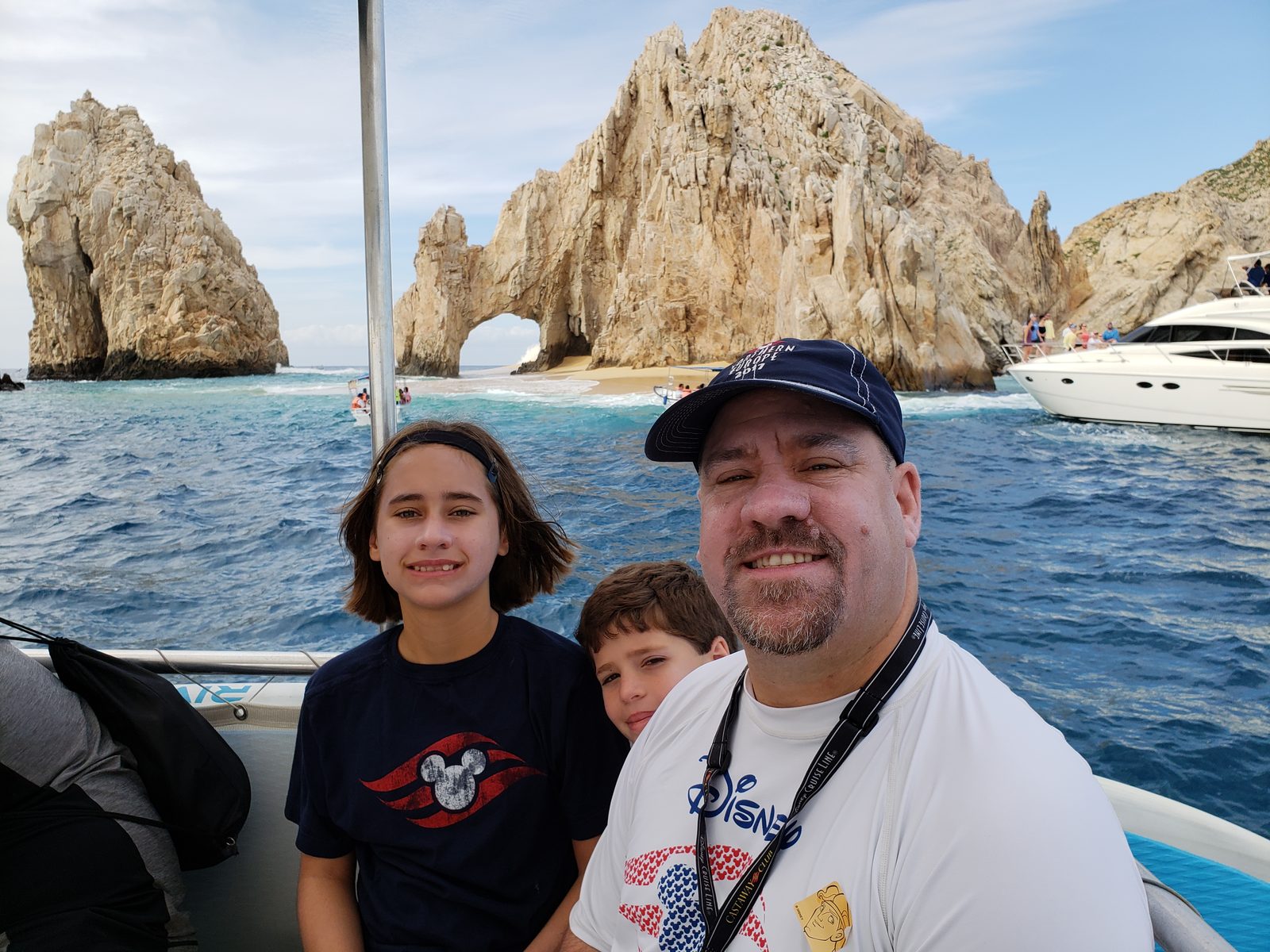 The kids and Michael sailing past El Arco