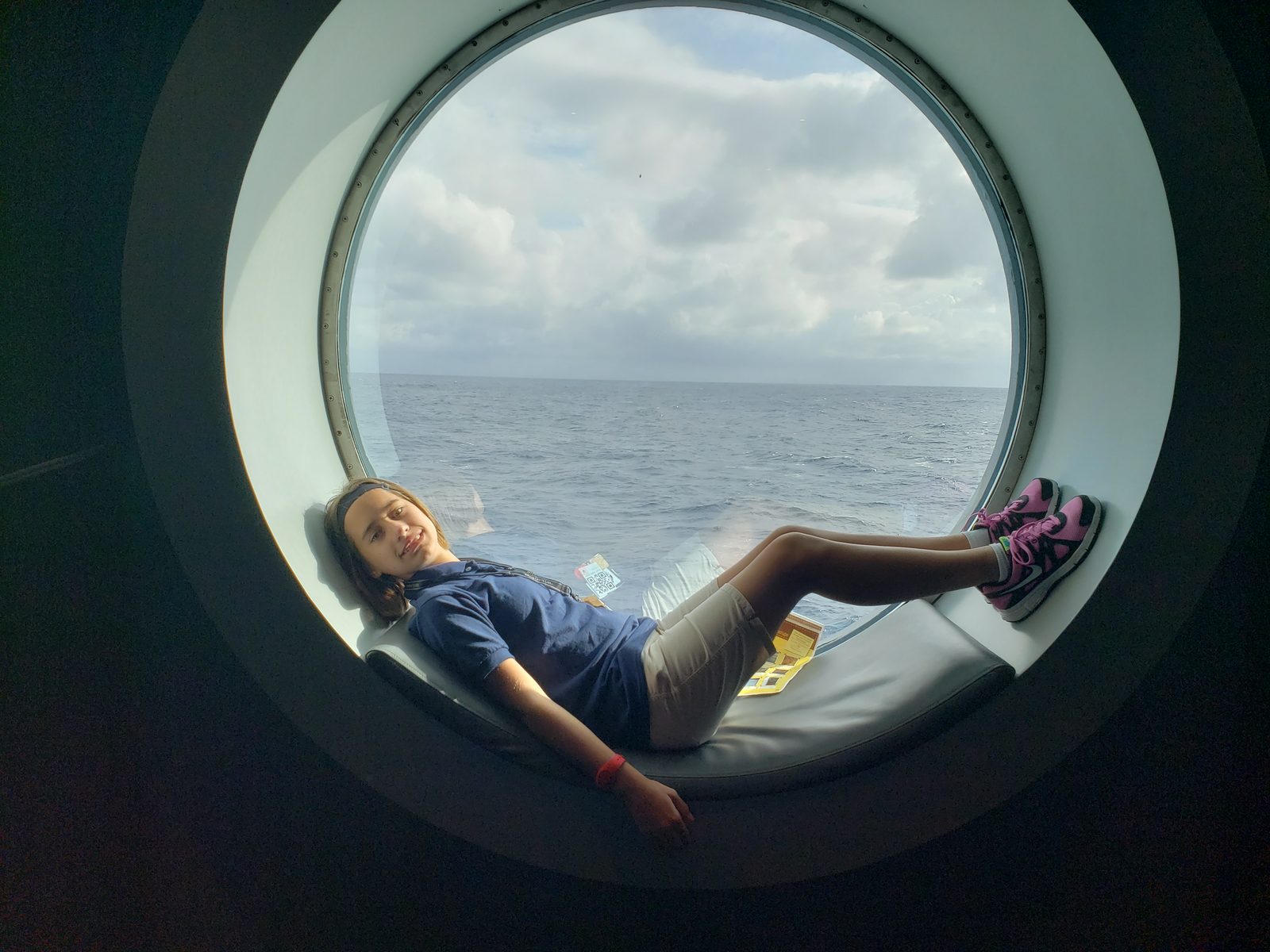 Lisa in a porthole window seat on the Wonder