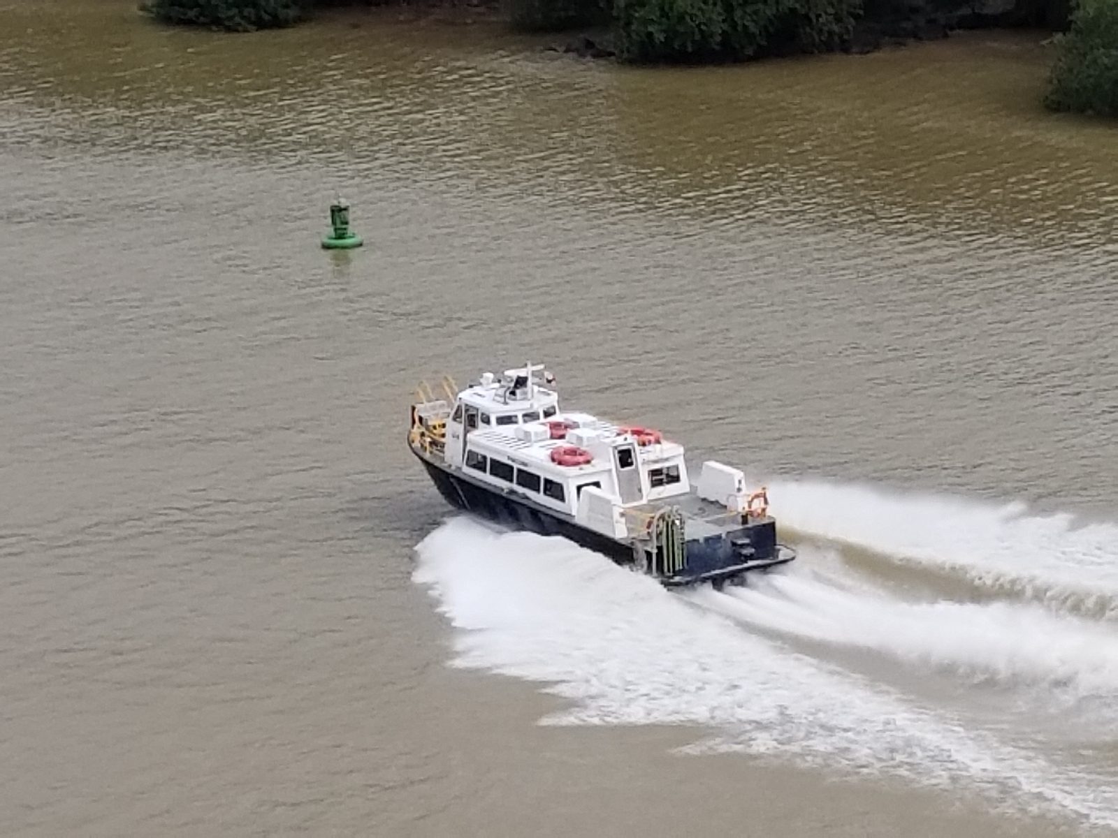 A canal pilot boat speeds past