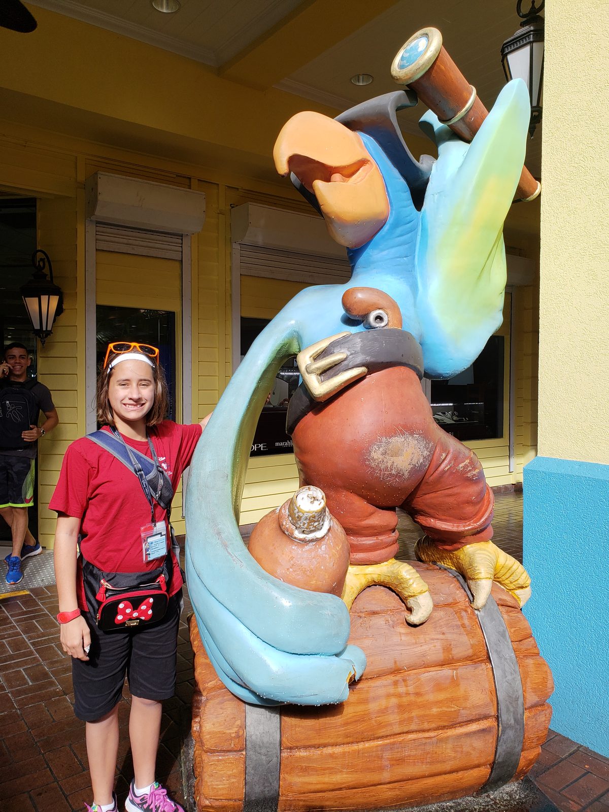 Lisa by a parrot statue in George Town
