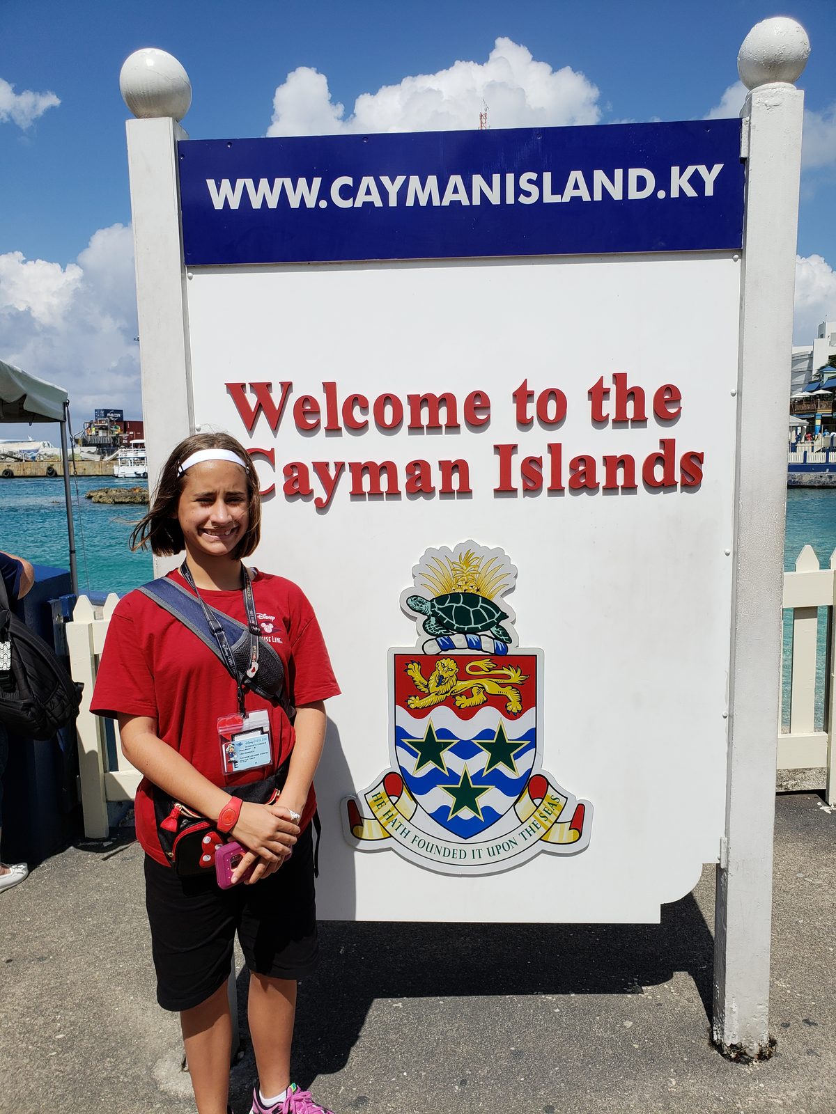 Lisa at the welcome sign in Grand Cayman