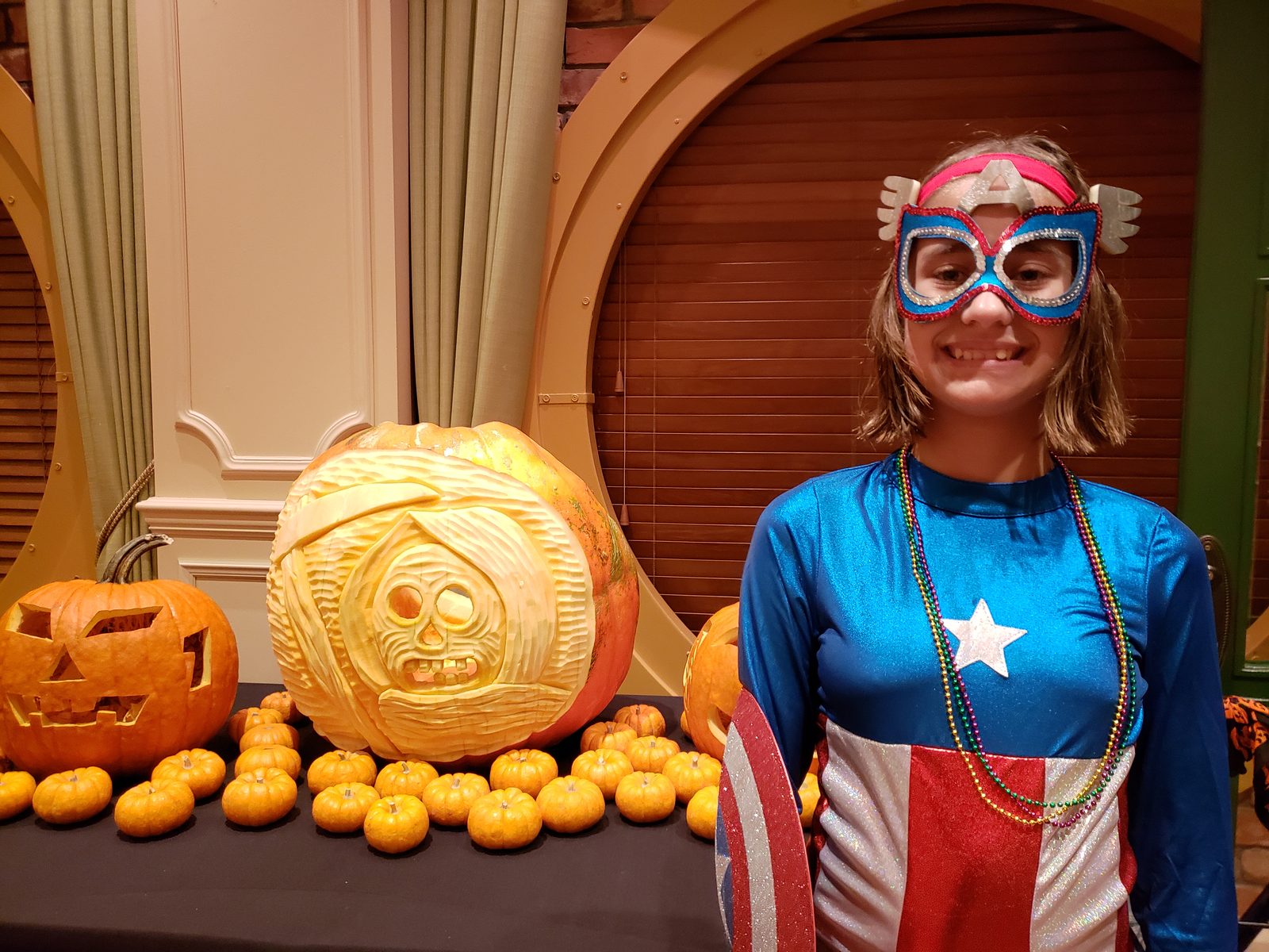 Lisa by the carved pumpkins in the atrium