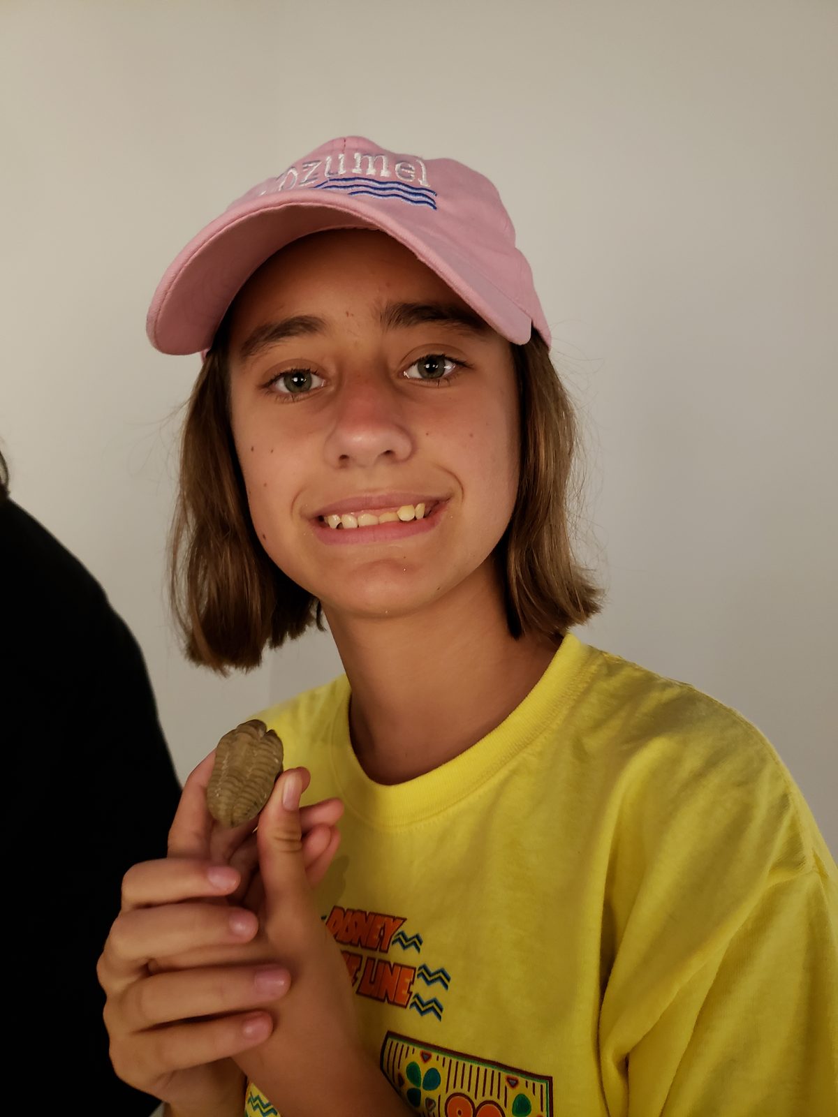 Lisa holds a trilobite fossil