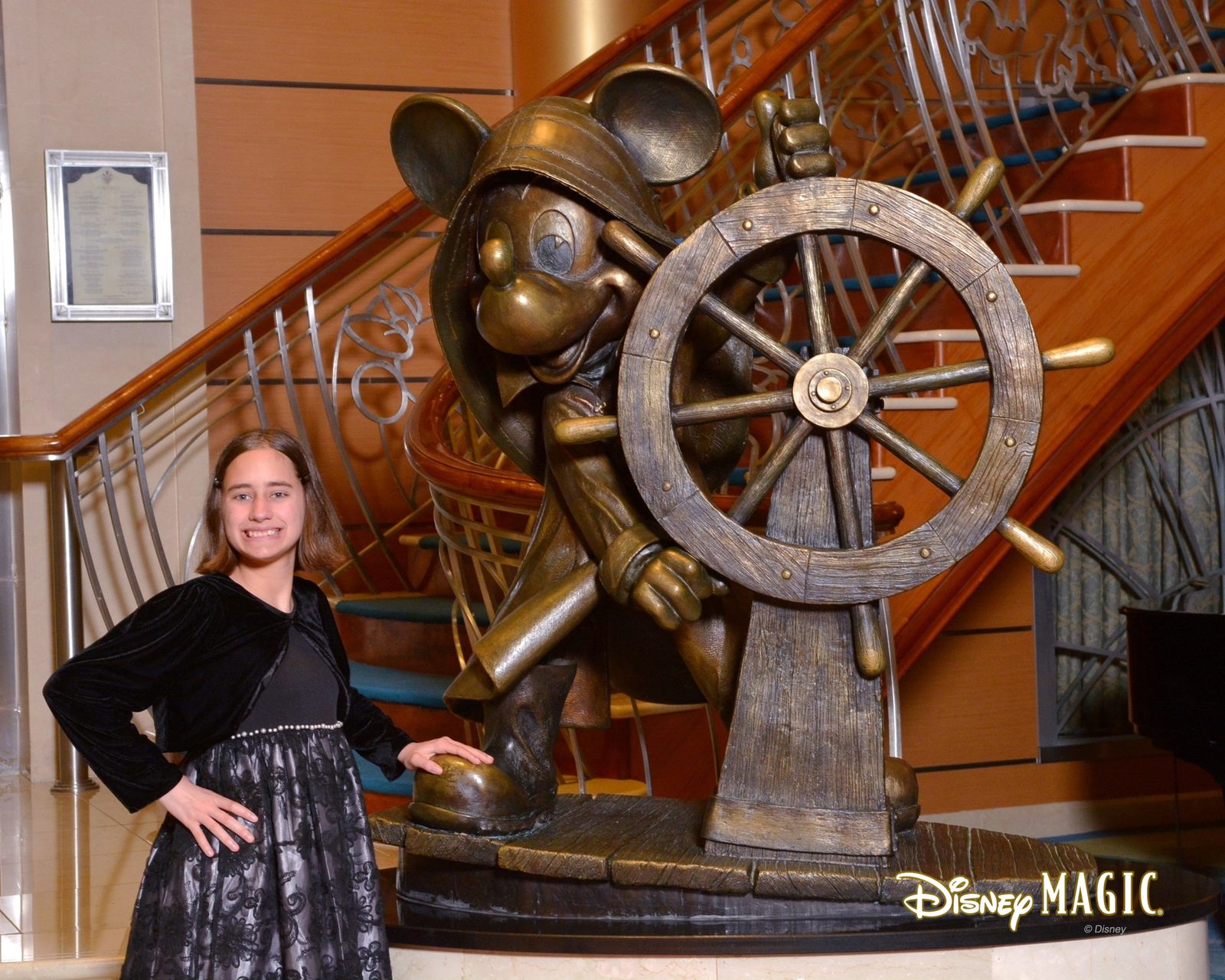 Lisa by the ship's wheel statue, dressed for formal night