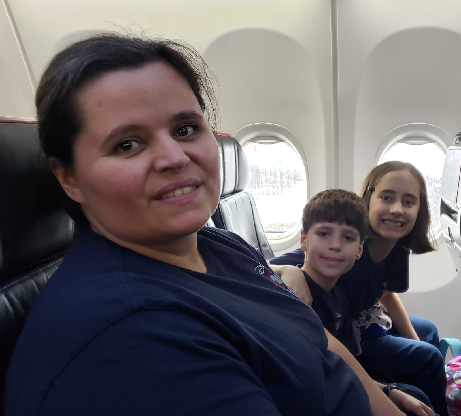 Kathy and the kids on our flight to Miami