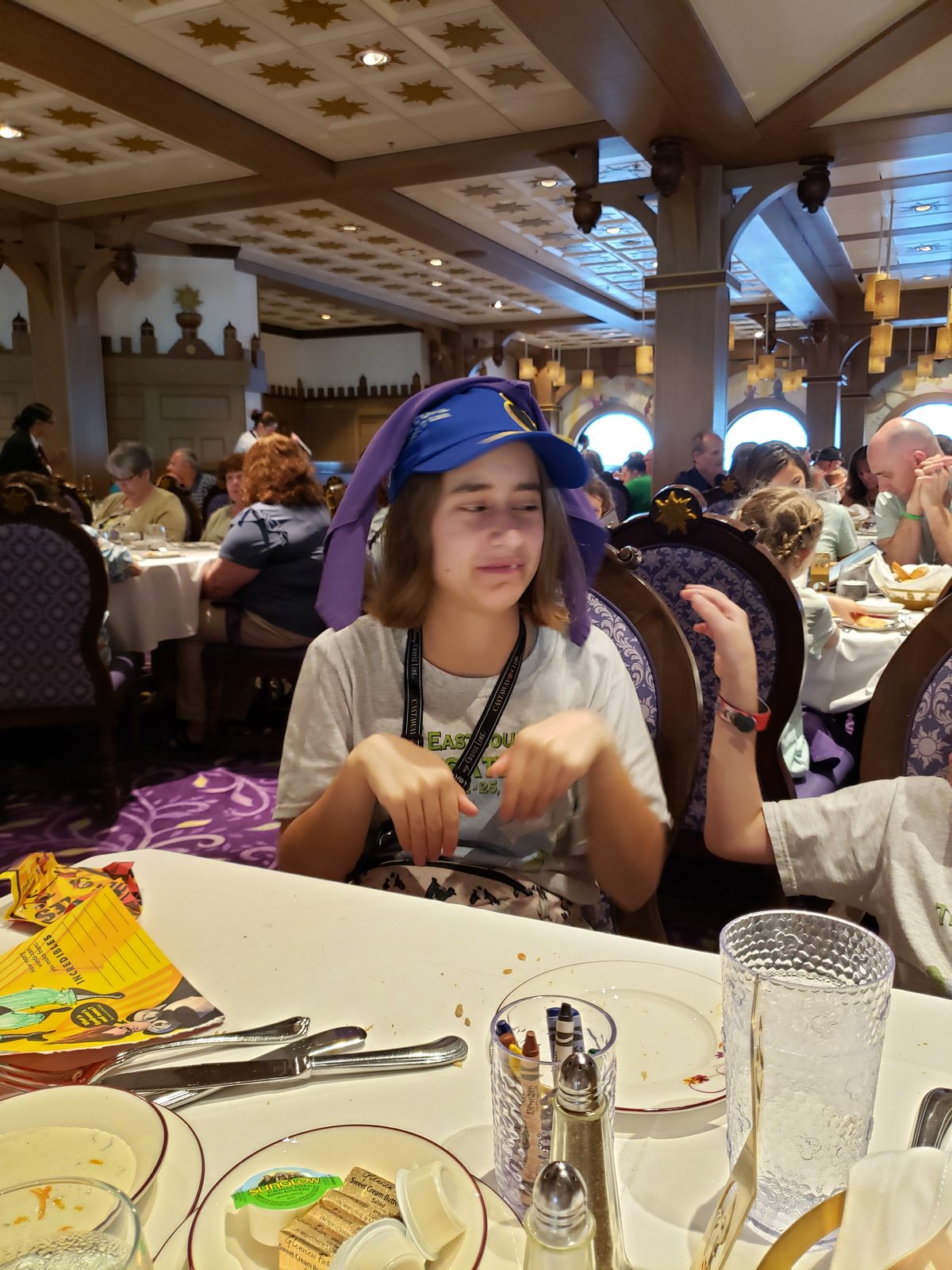 Lisa wears her napkin as a hat at dinner