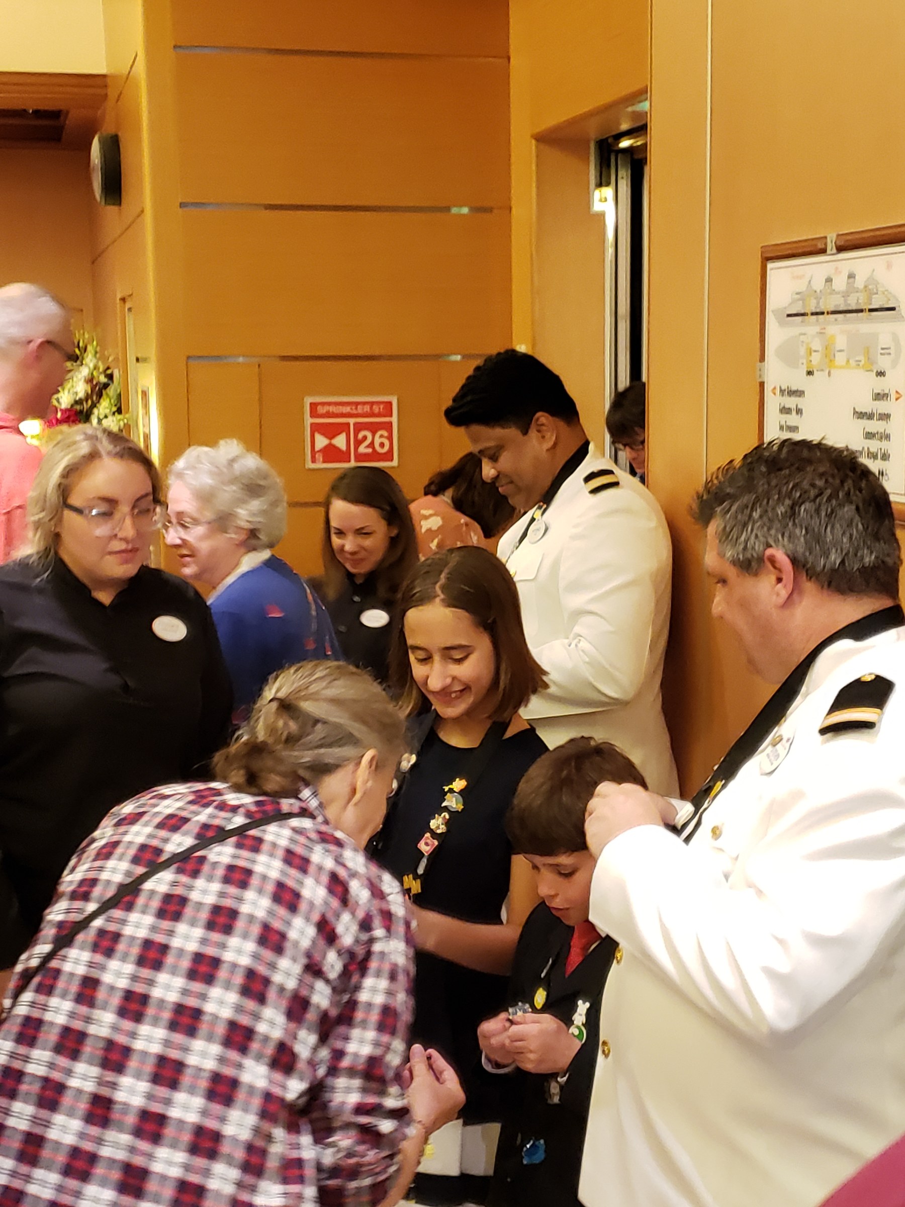 Frankie, LeAnn, Stephanie, Lisa, Thomas and Steven at pin trading with the ship's officers, LeAnn trading pins with Lisa