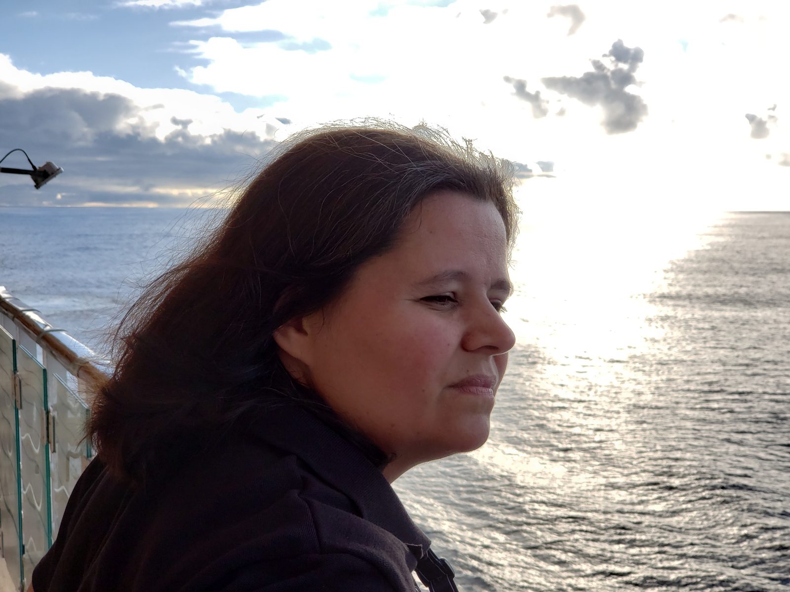 Kathy watching the sunset over the water