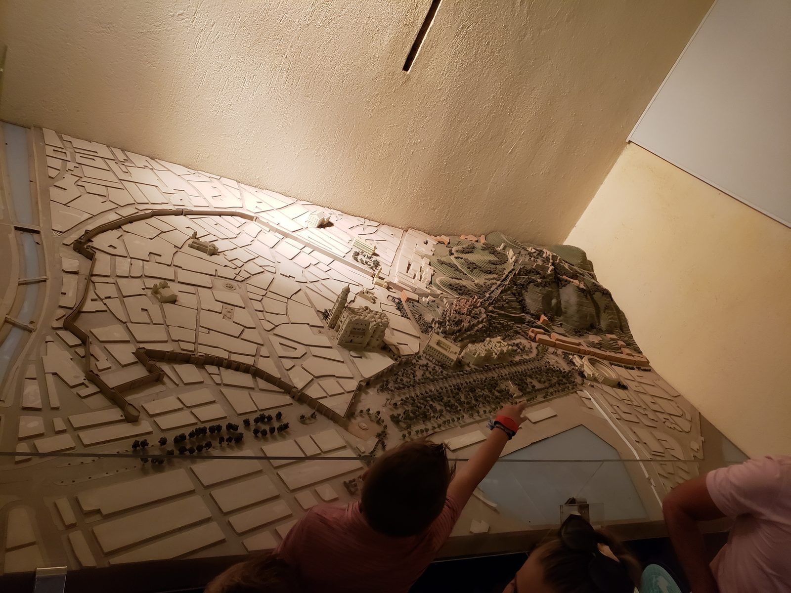 Pointing out the castle on a scale model