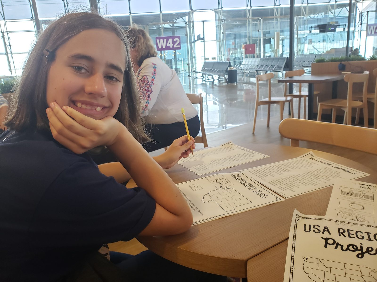 Lisa doing schoolwork at the gate