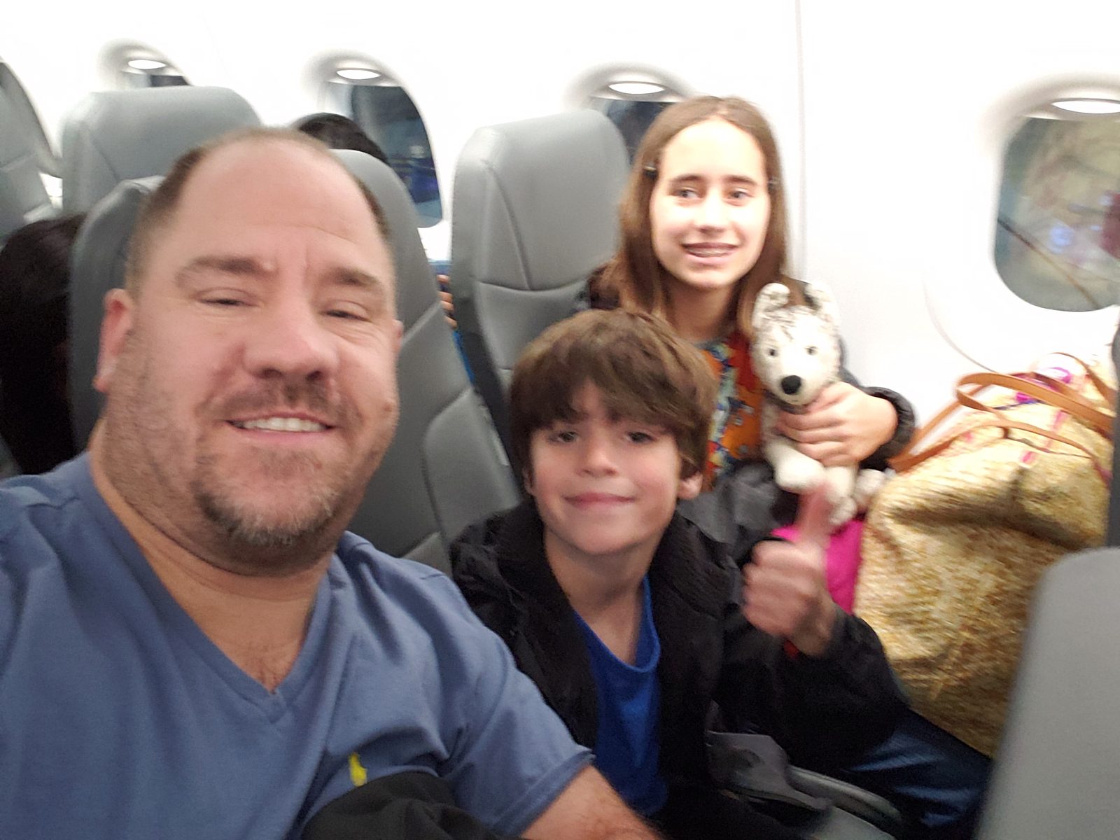 Thomas, Lisa and Bob the husky on our flight to Orlando