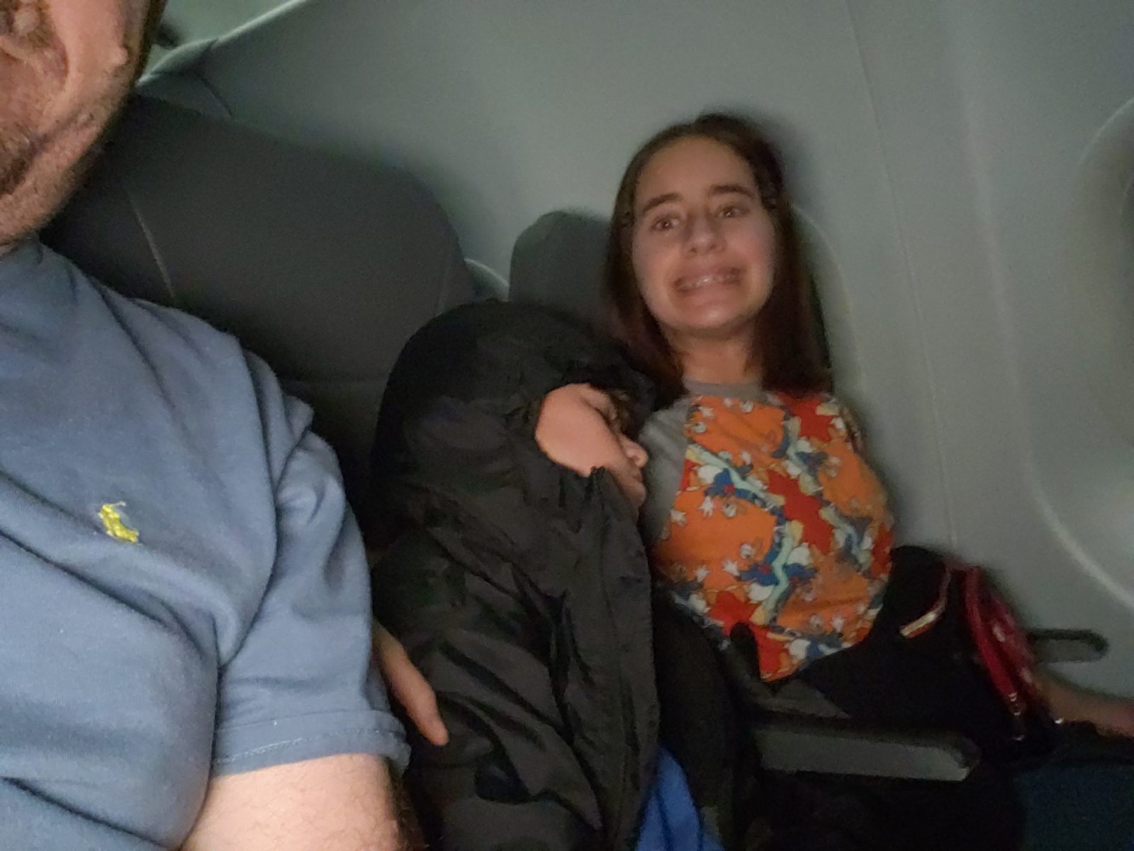 Lisa grinning beside me on the flight
