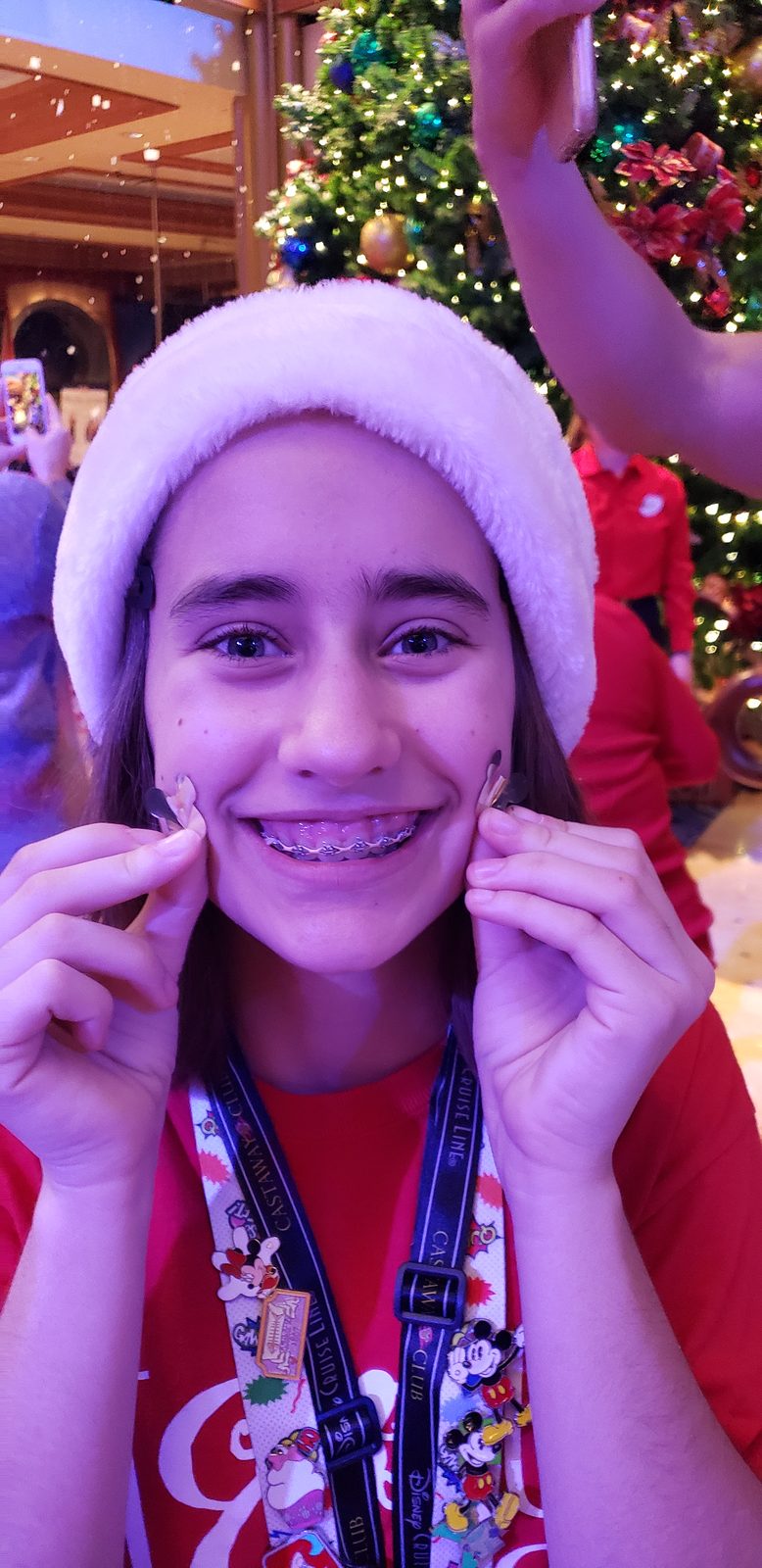 Lisa in her Santa hat by the atrium tree on the Dream