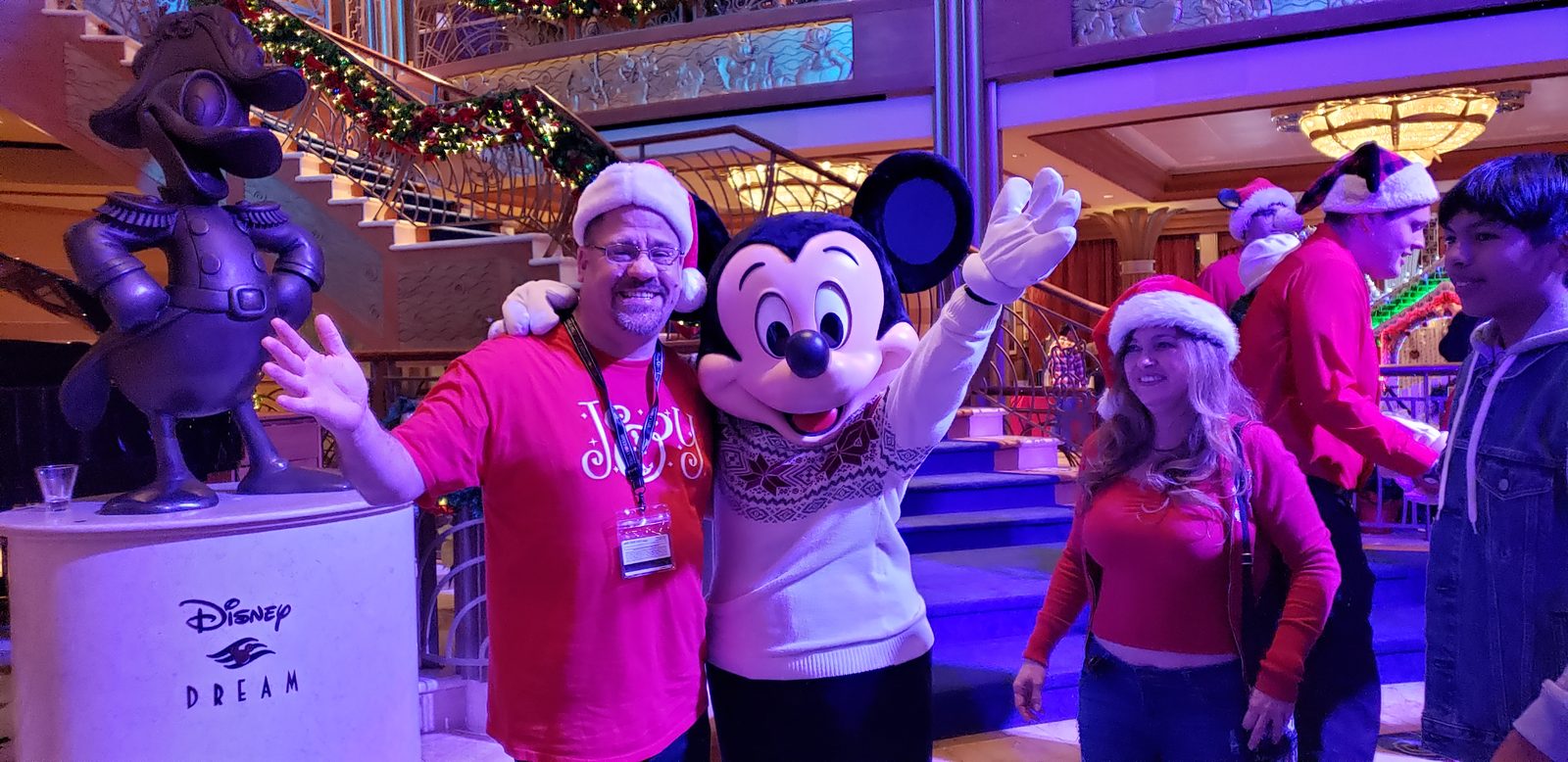 Michael with Mickey in his Christmas sweater in the Lobby Atrium