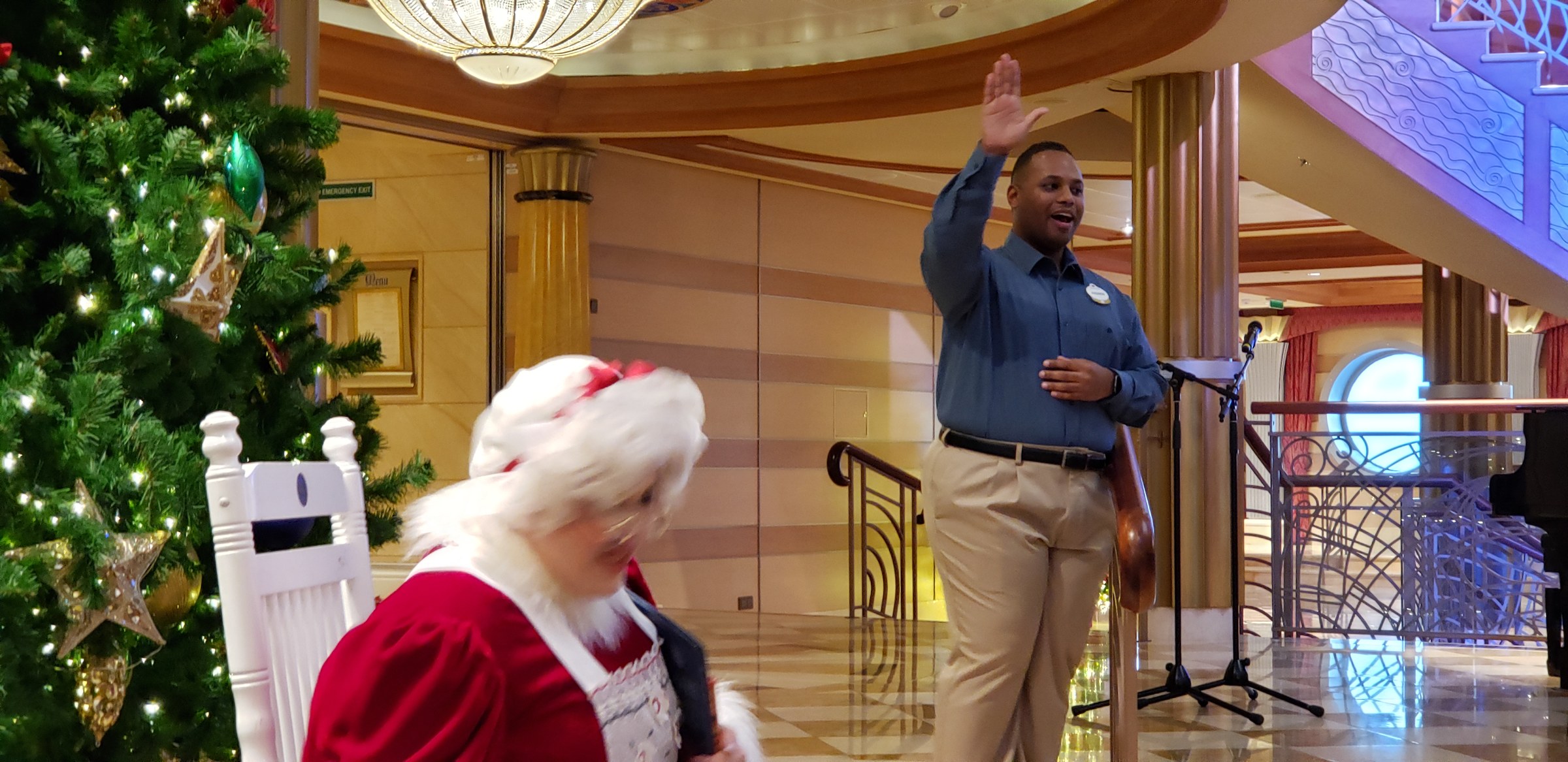 Mrs. Claus reads the Christmas story in the Lobby Atrium as ASL interpreter Andrew signs