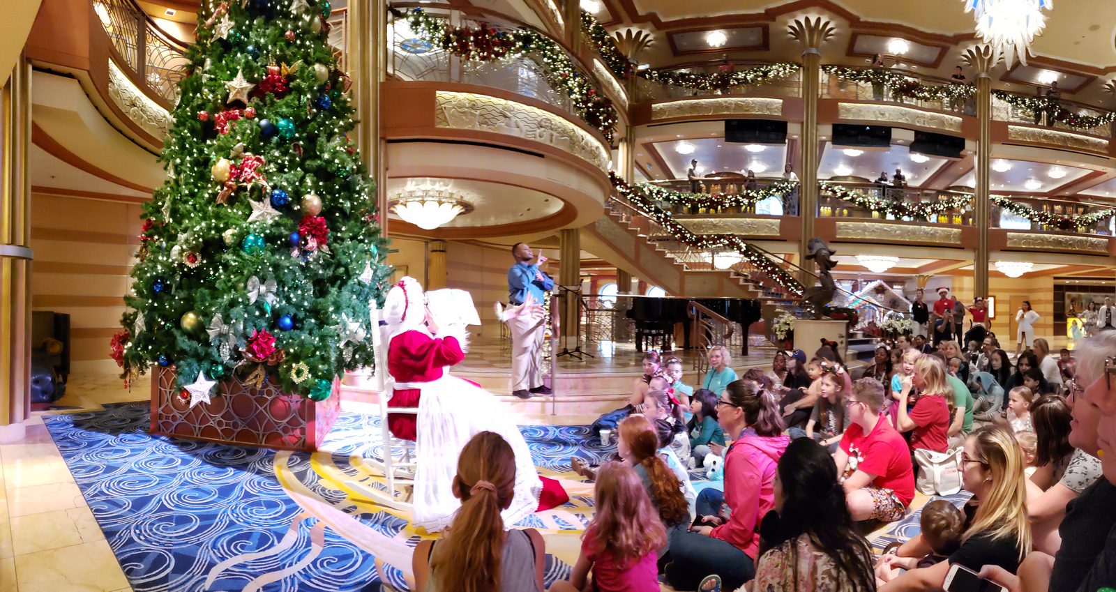 Mrs. Claus reads a Christmas story to kids in the Lobby Atrium, with ASL interpreter Andrew for Lisa