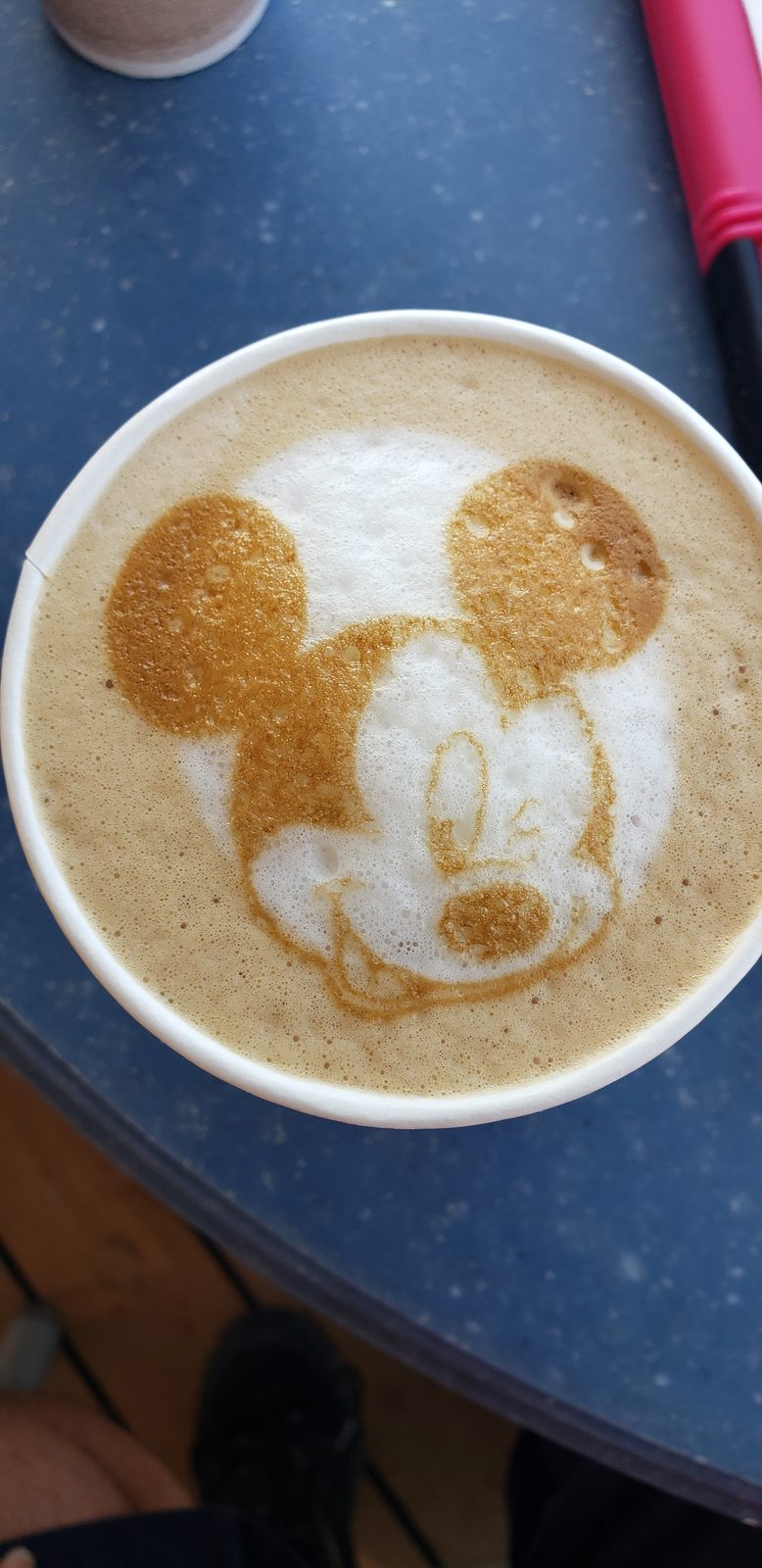 A latte with Mickey drawn in the foam
