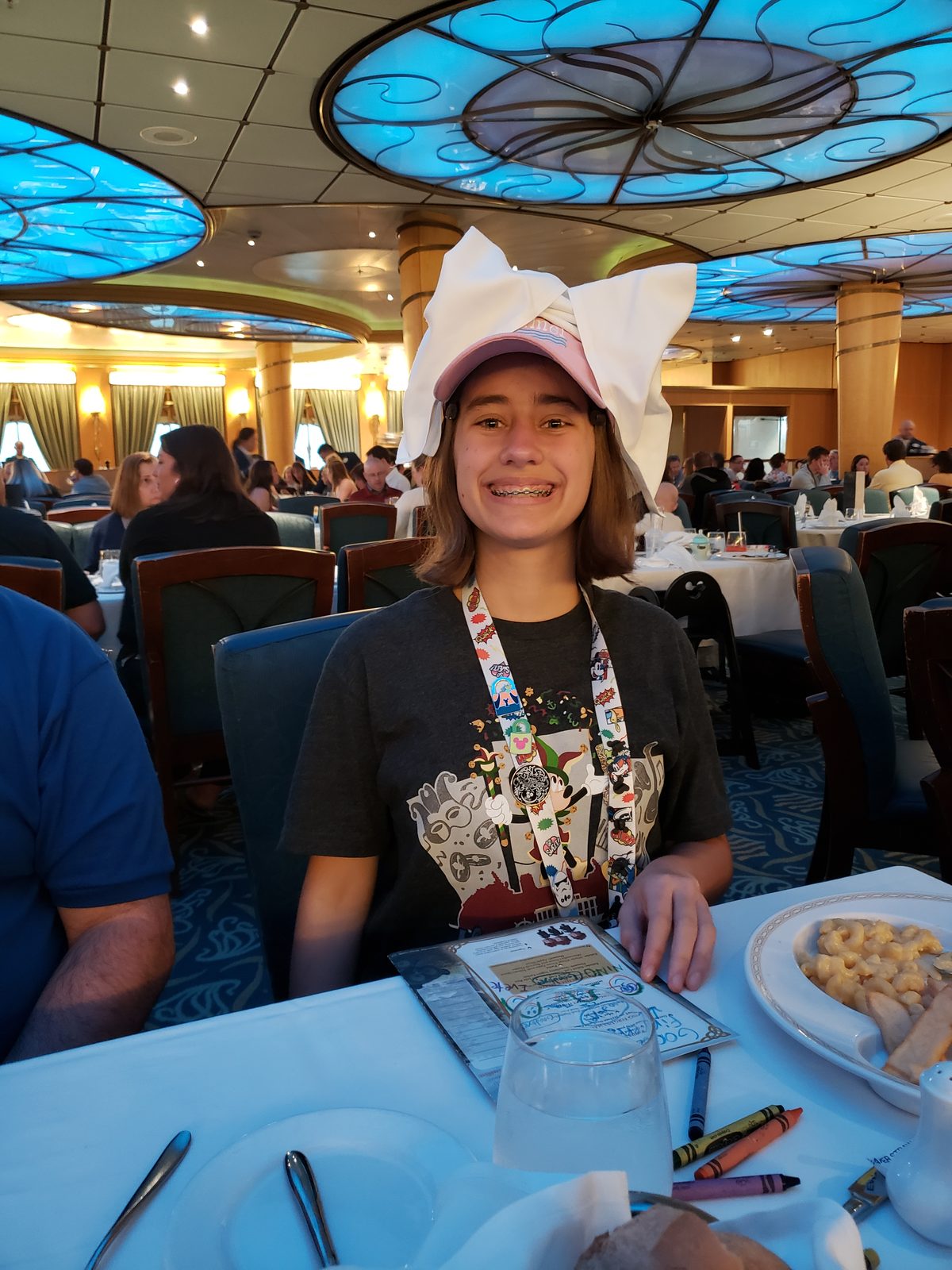 Lisa in a pink cat-ear hat at dinner