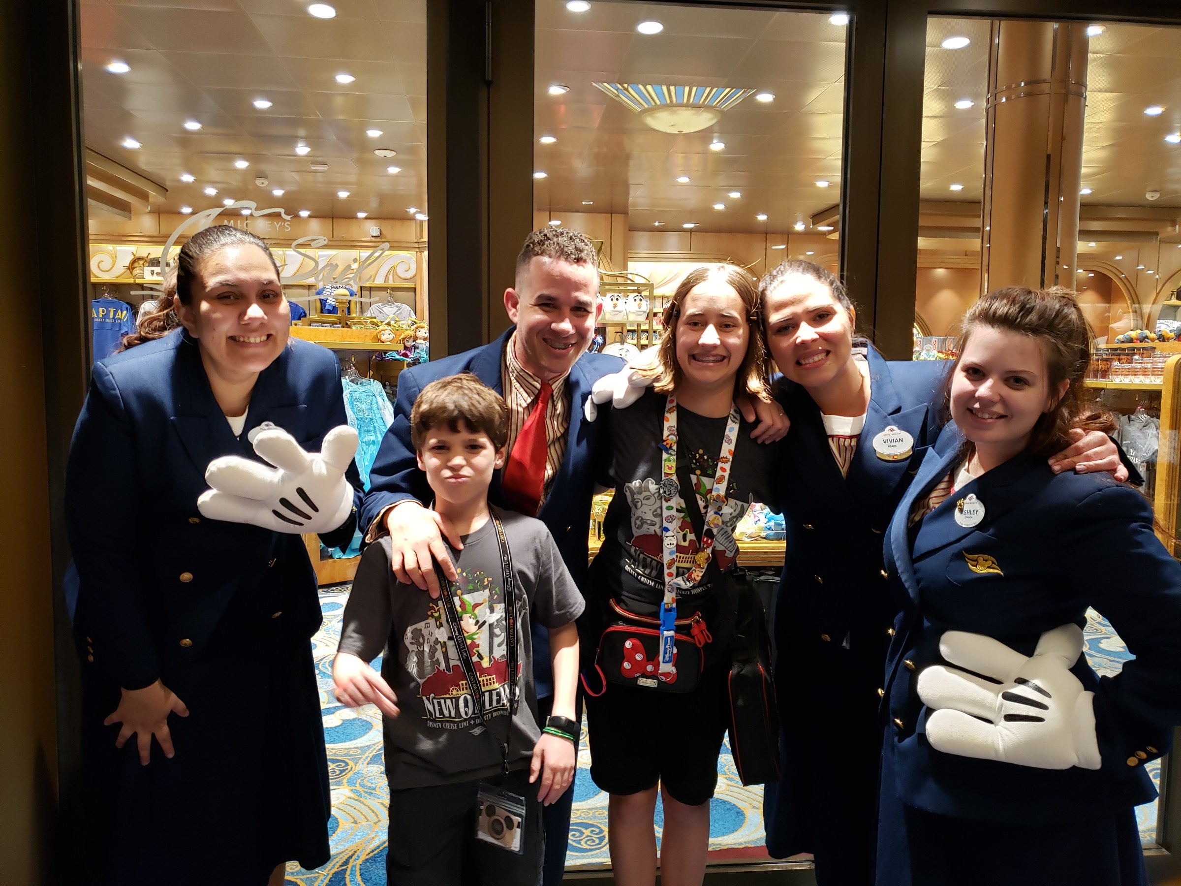 Thomas, Eddisson and Lisa with the shop Cast Members, Mickey gloves and all