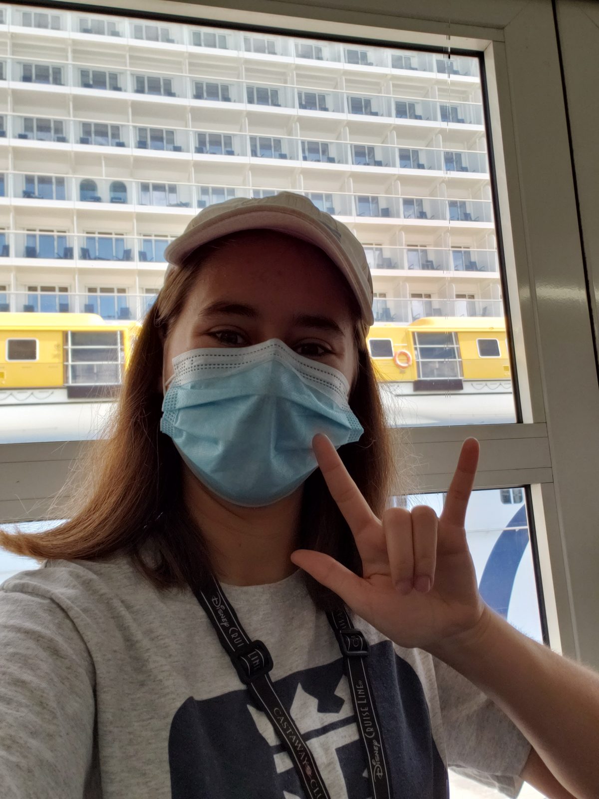 Lisa's masked selfie with the ship behind her