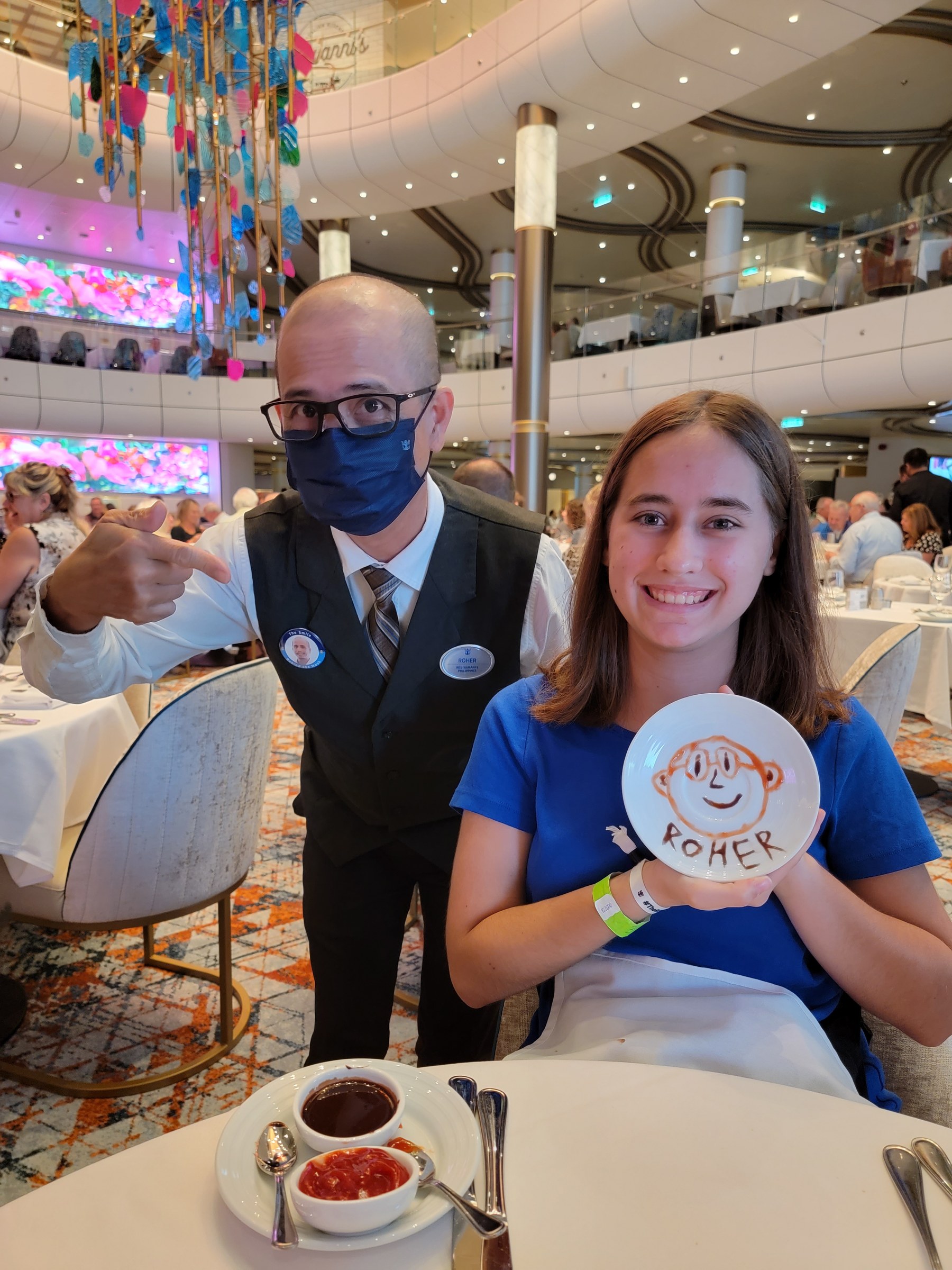 Roher, our server, with Lisa and the portrait of him she painted on a plate