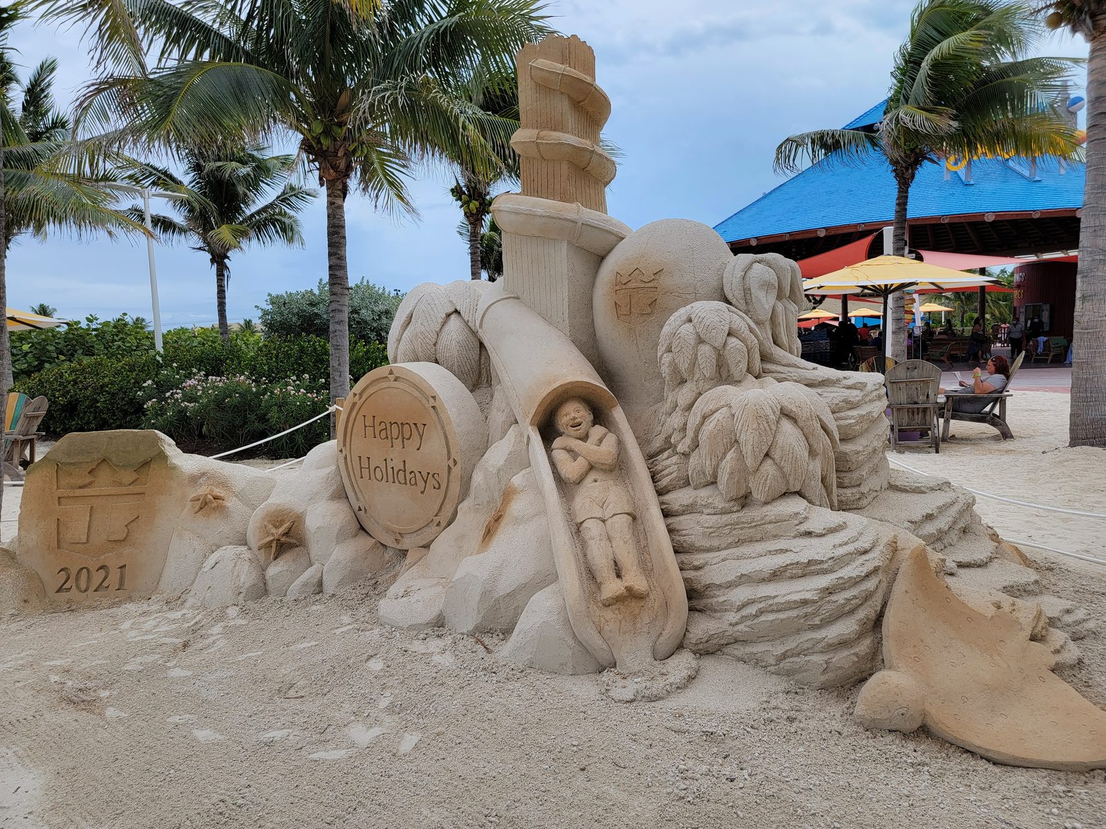 A sand sculpture reads Happy Holidays 2021