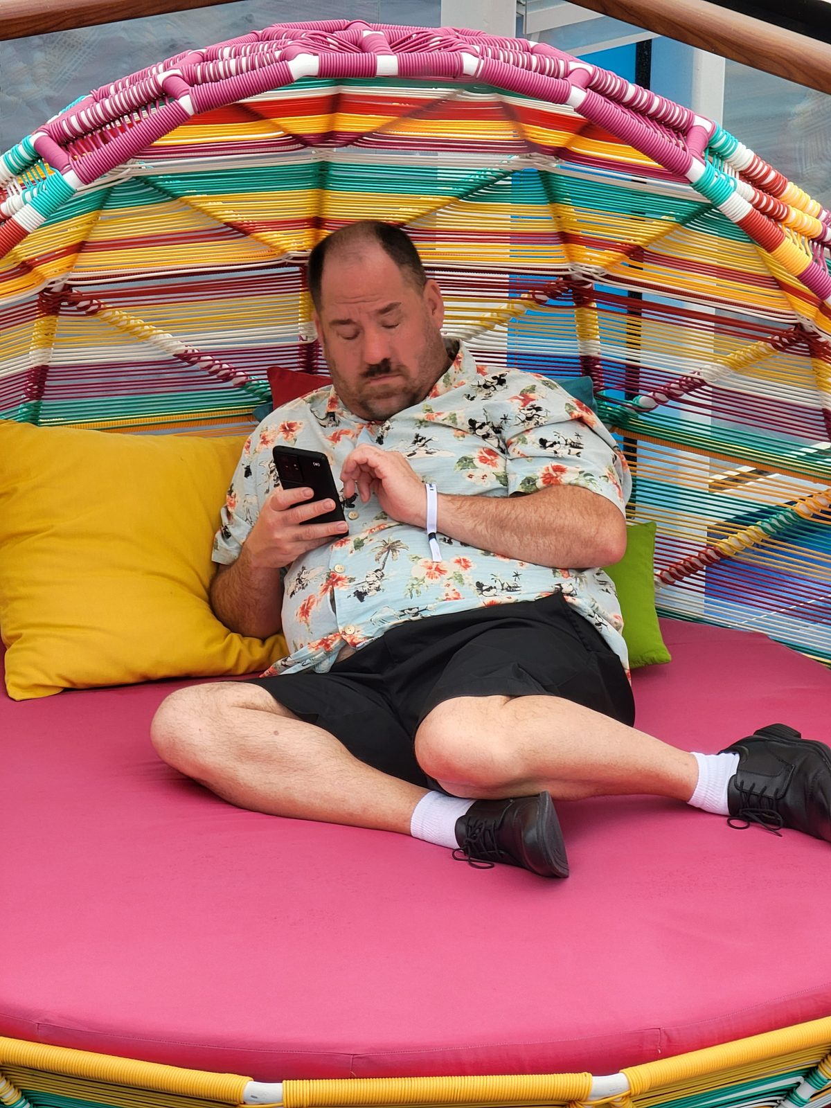 Me relaxing in a poolside basket chair