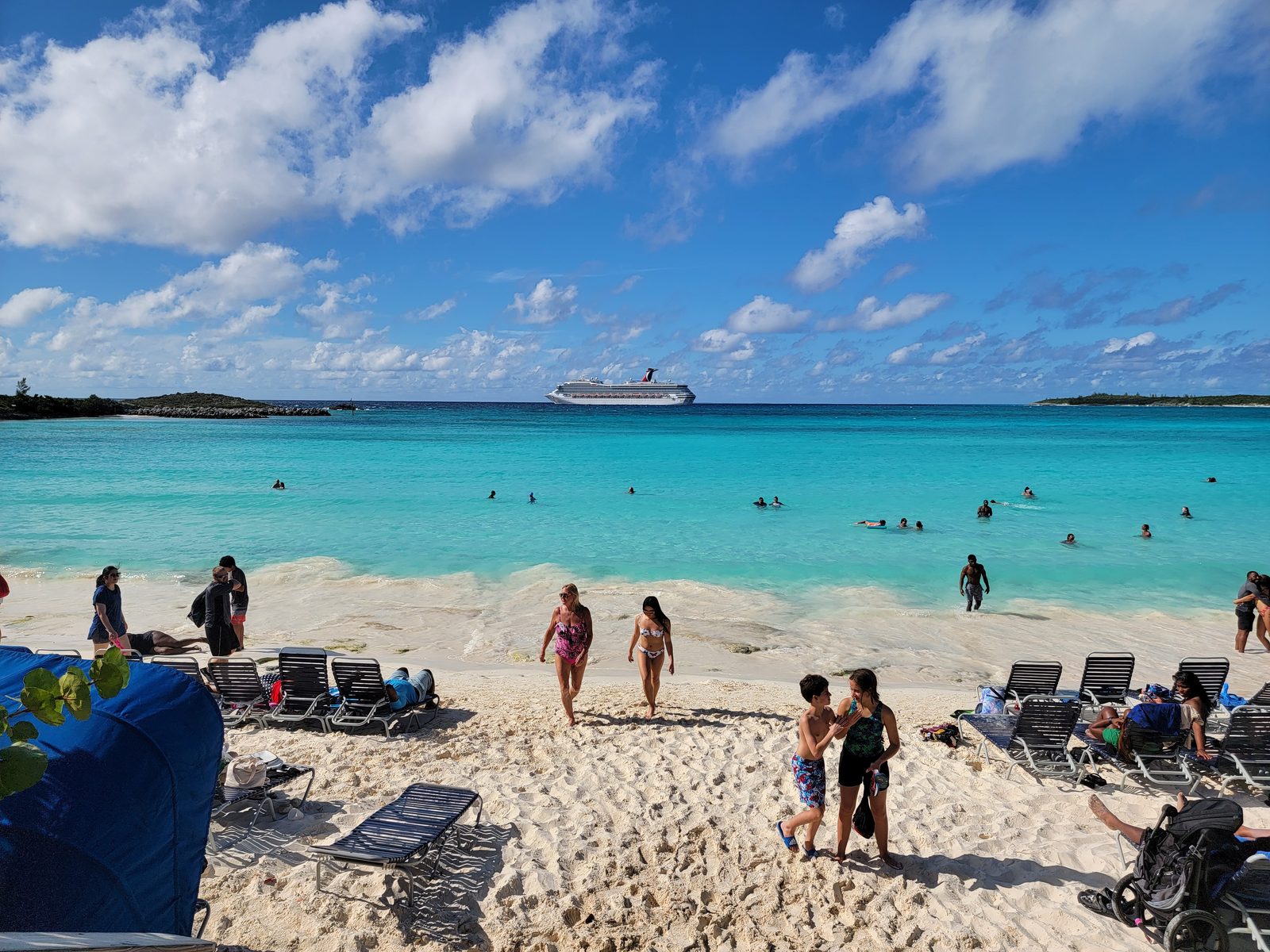 The beach at Half Moon Cay with the Conquest behind