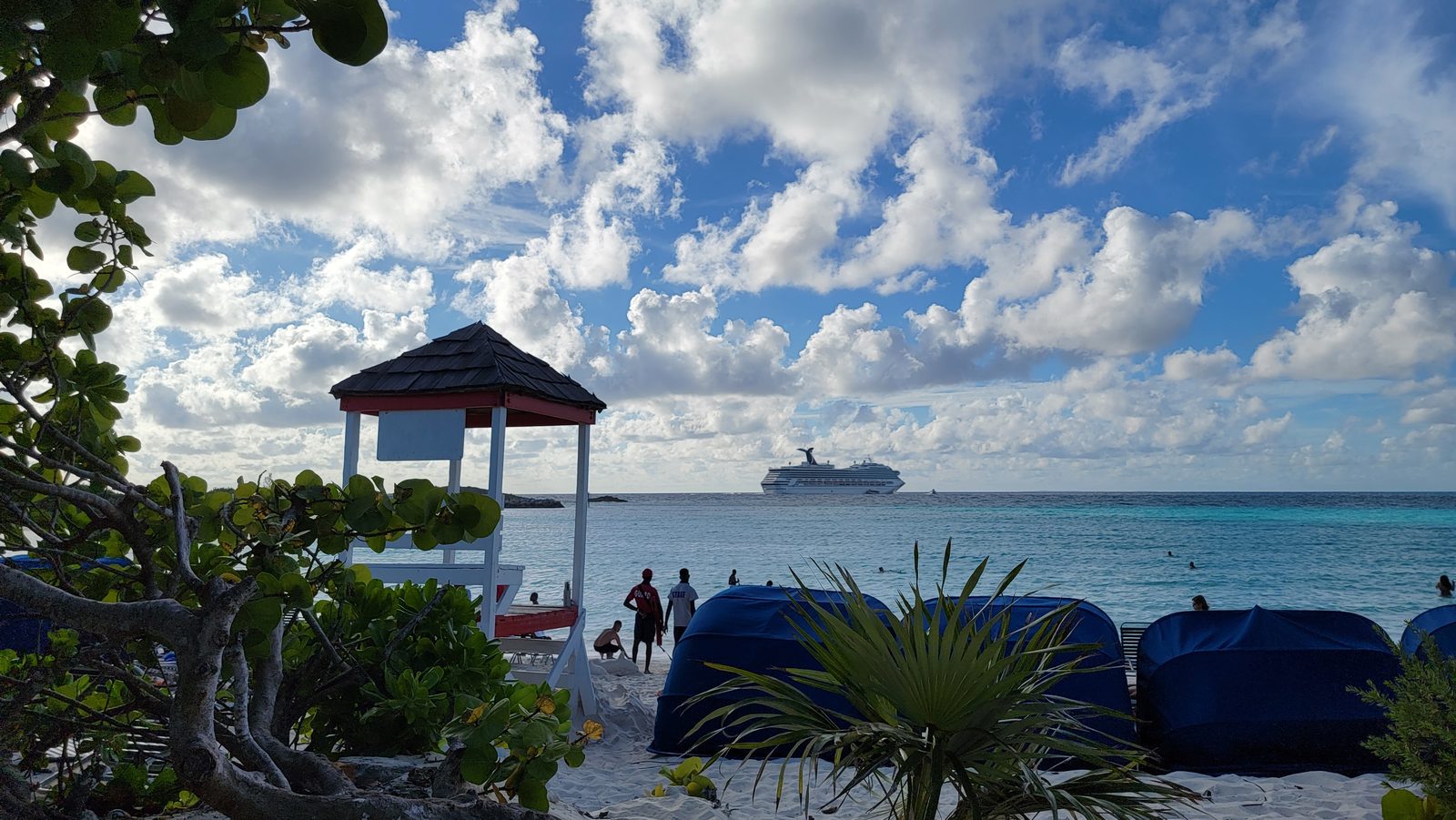 A beach pavilion with the ship offshore