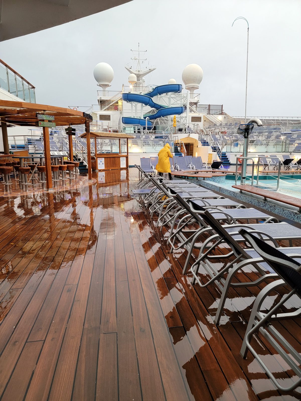 Rain-slicked pool deck, empty this early