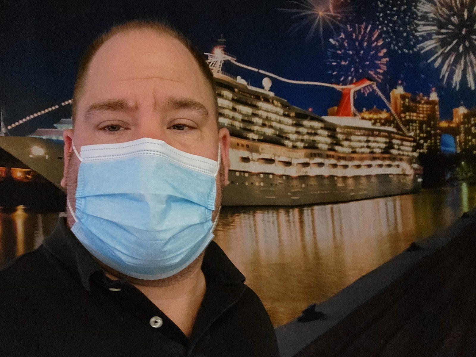 Masked up with the ship lit up behind me