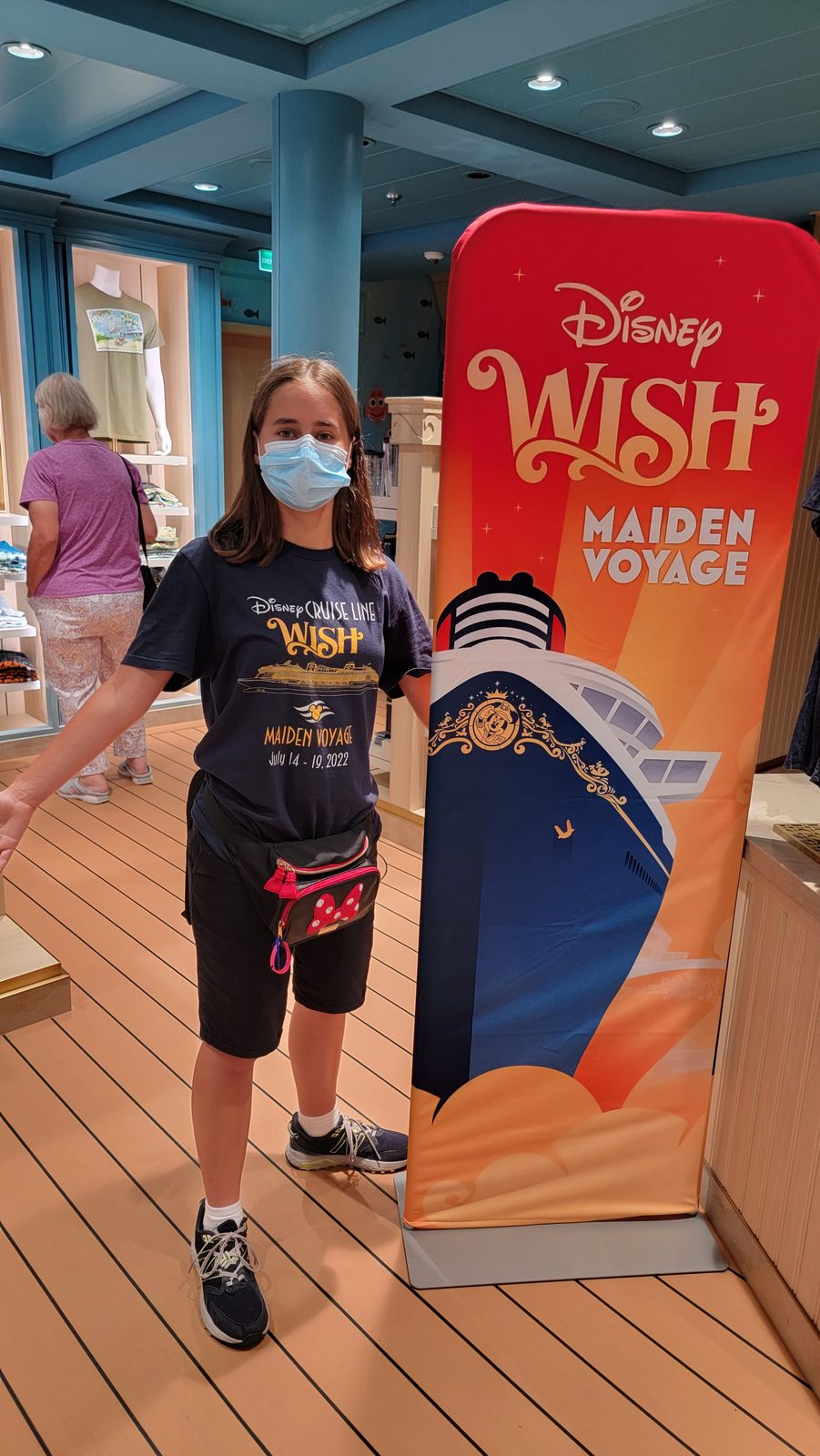 Lisa beside the Maiden Voyage sign on the Wish