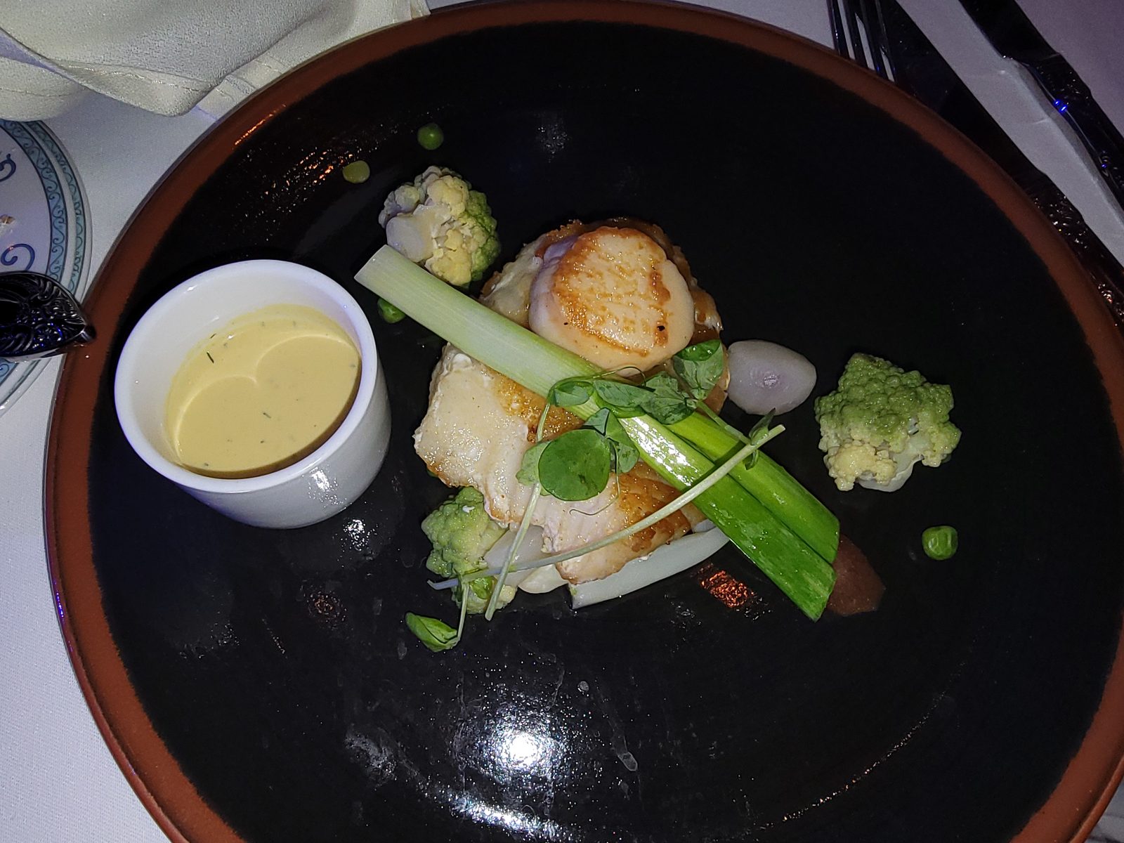Scallop and vegetable plate at dinner