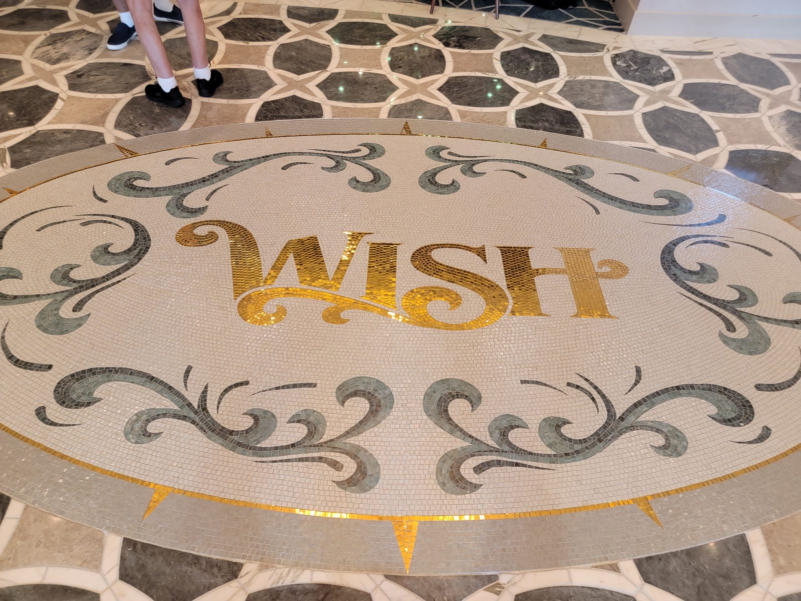 The gold WISH medallion in the Grand Hall floor