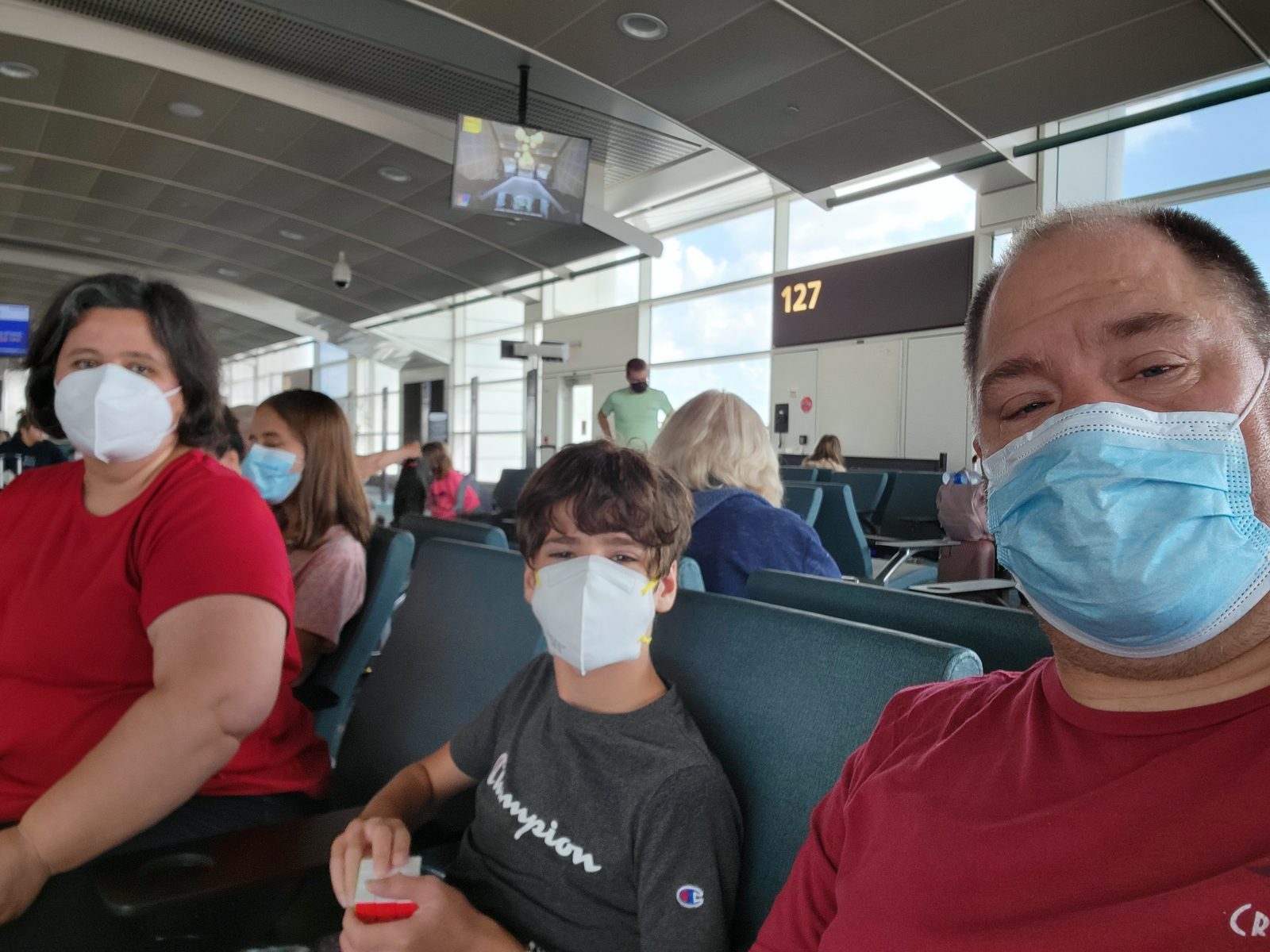 Waiting at the gate with masks on, heading home