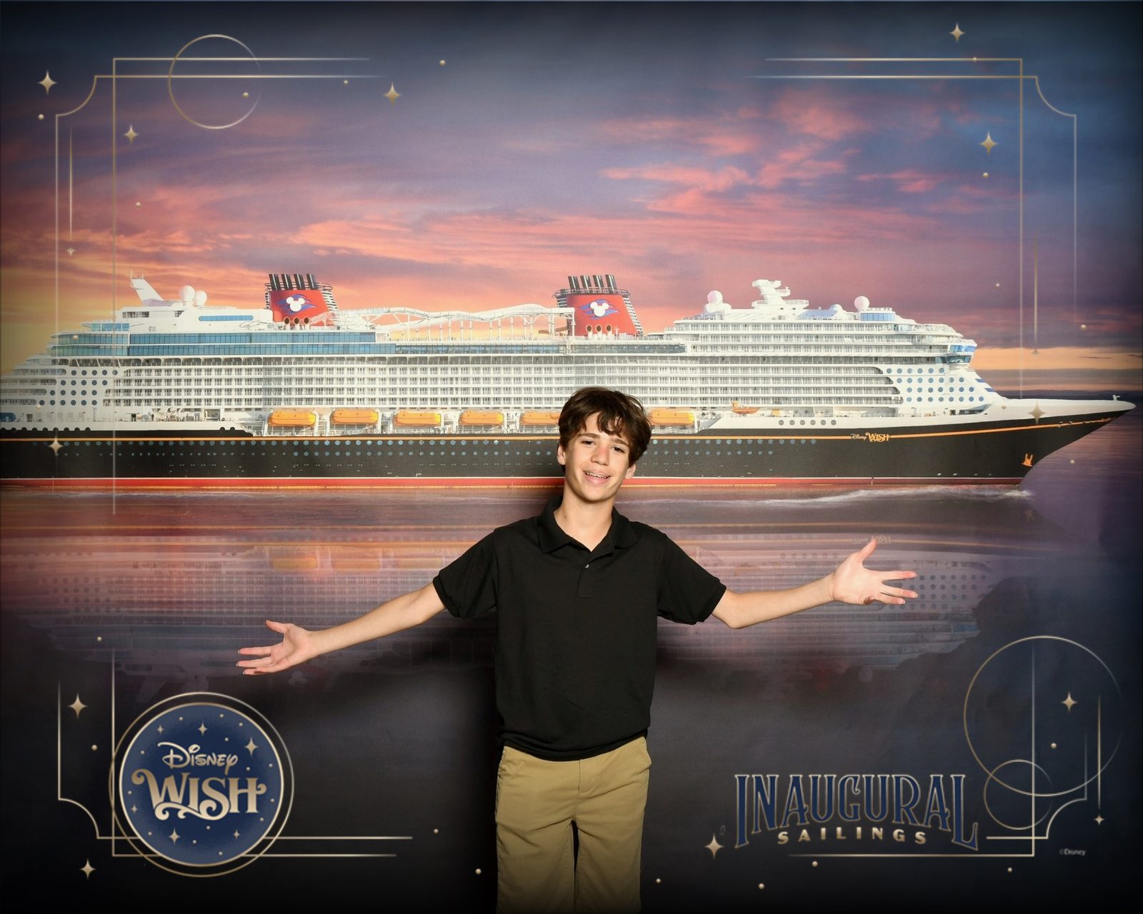 Thomas in front of the Wish sunset backdrop