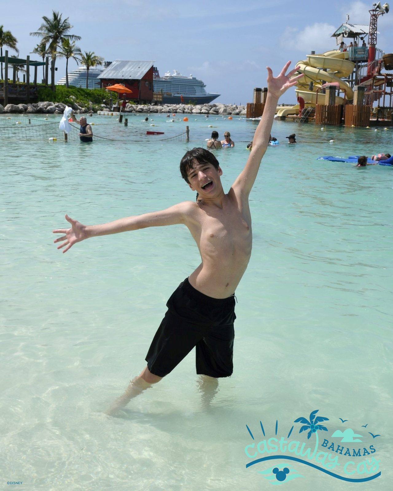 Thomas jumping for joy in the shallows at Castaway Cay