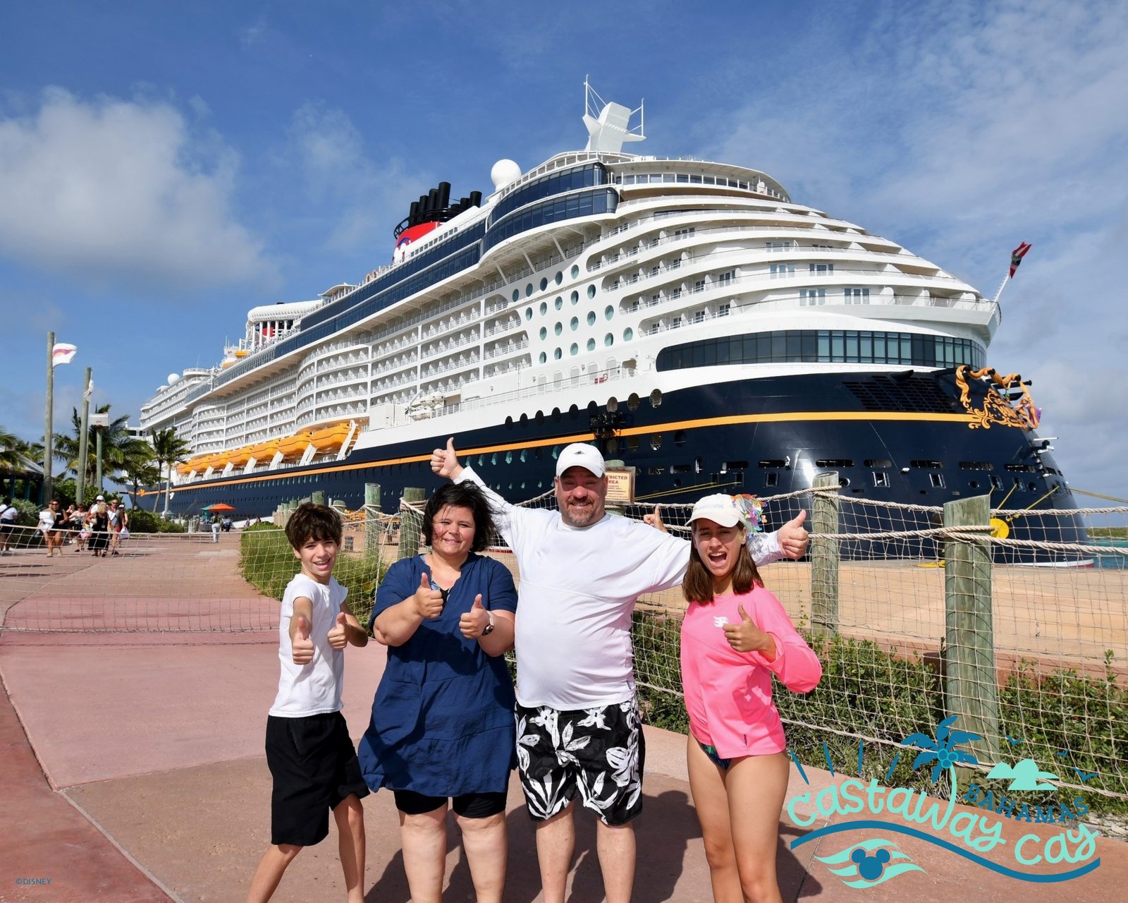 The four of us at Castaway Cay with the Wish behind