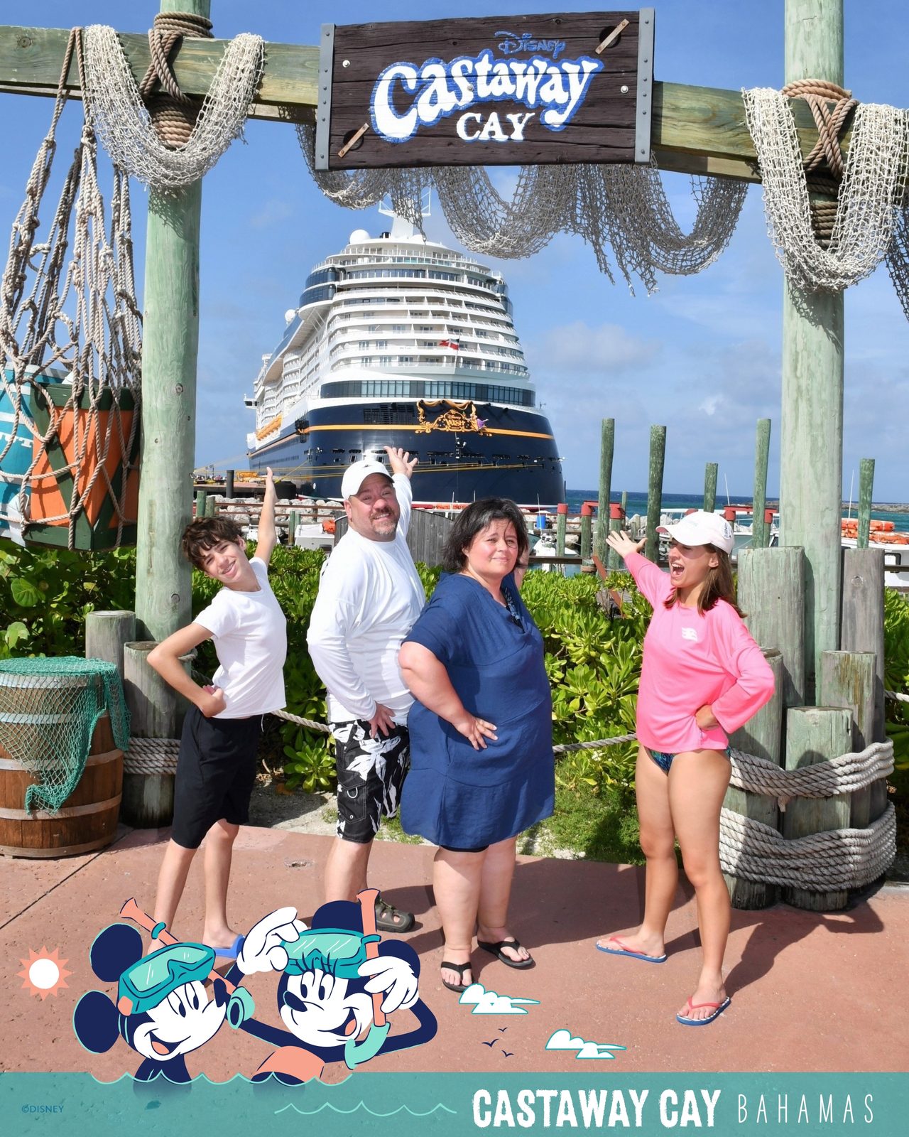 Under the Castaway Cay sign with the Wish behind us