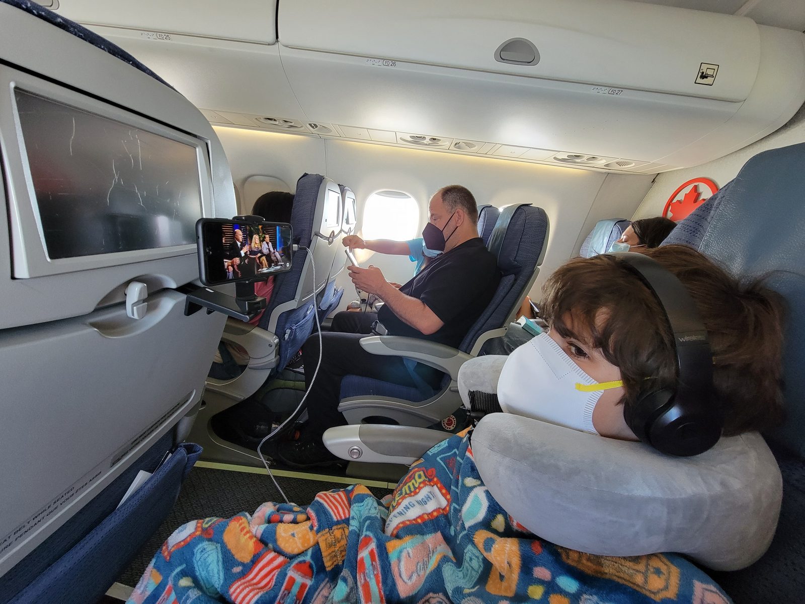 Thomas asleep against the window early in the flight