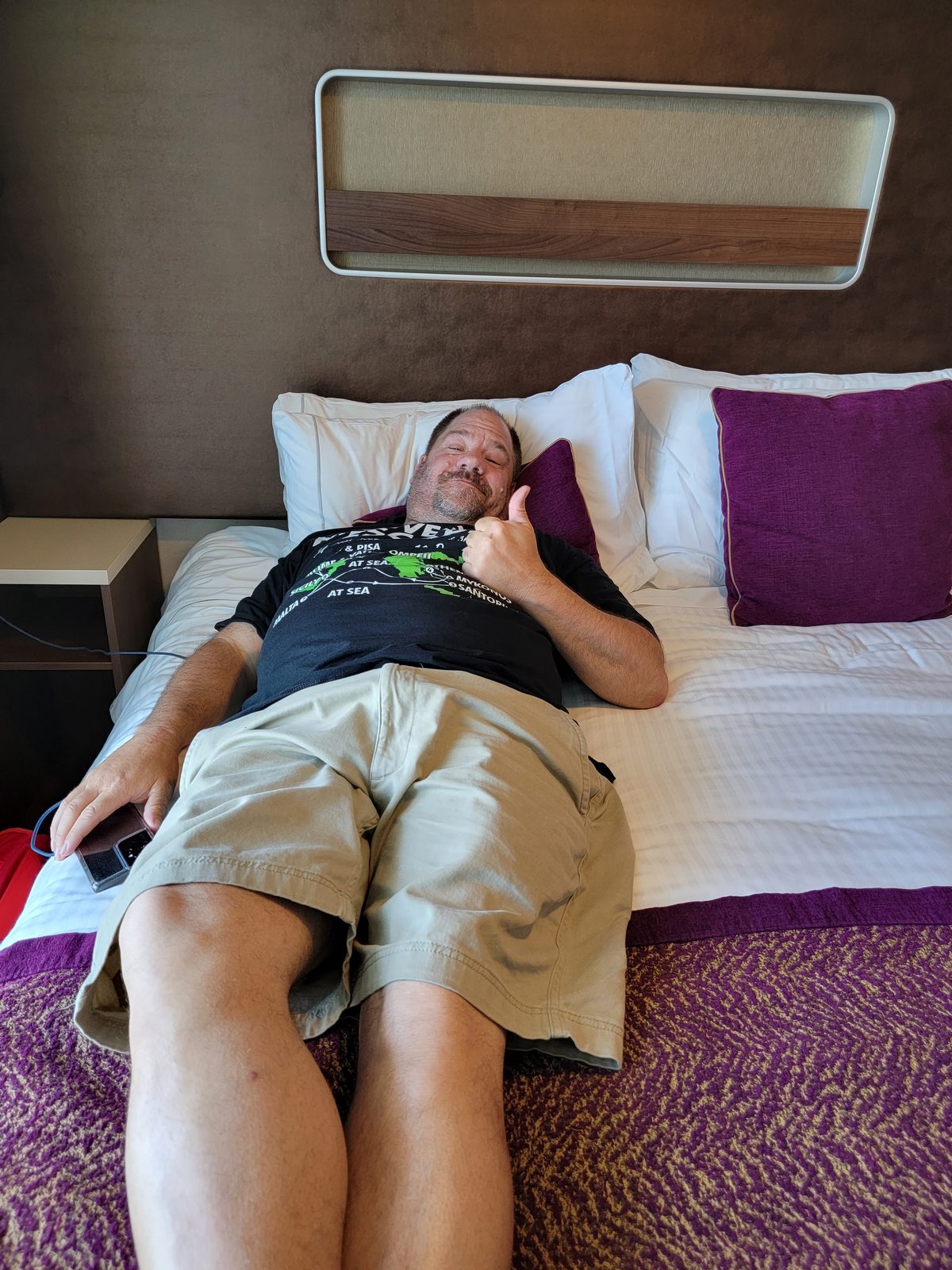 Giving a thumbs up from our stateroom bed