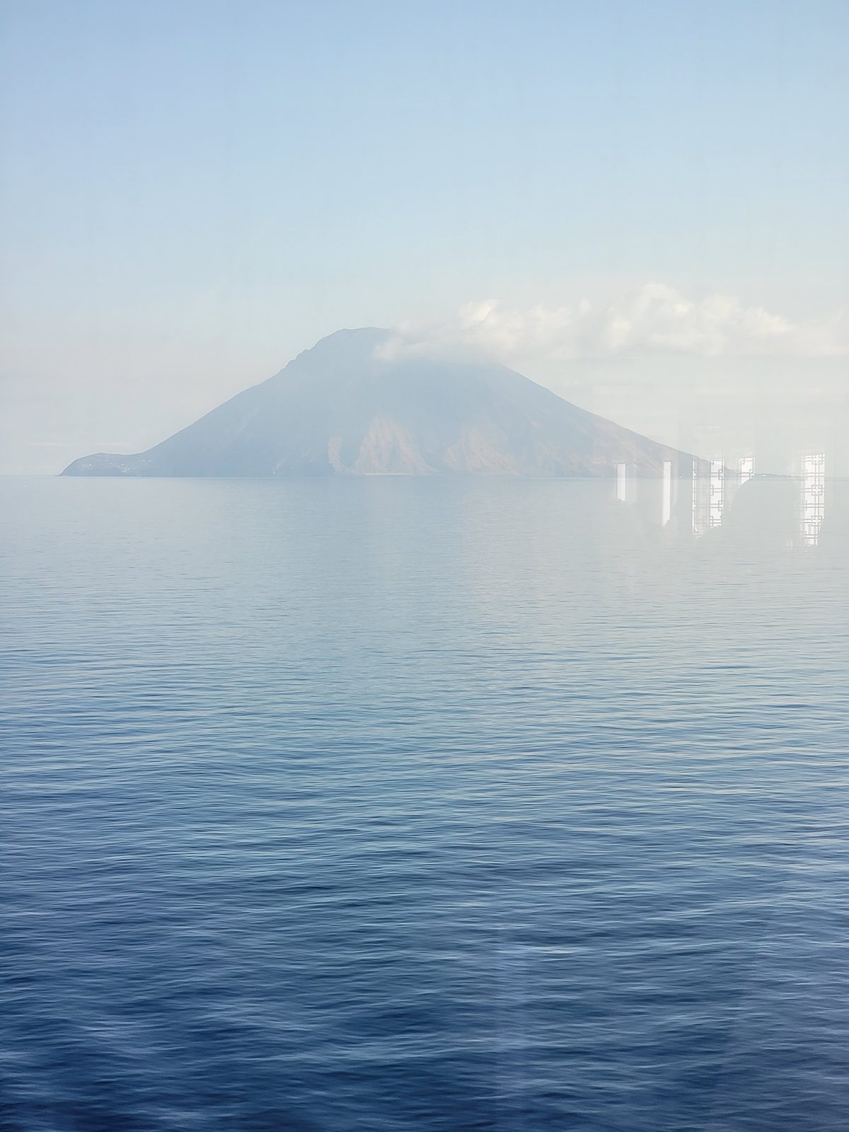 A hazy volcanic island from our day at sea