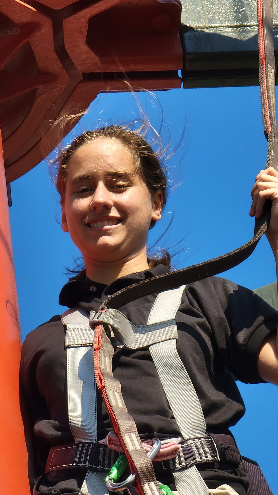 Lisa working the ropes course high above the pool