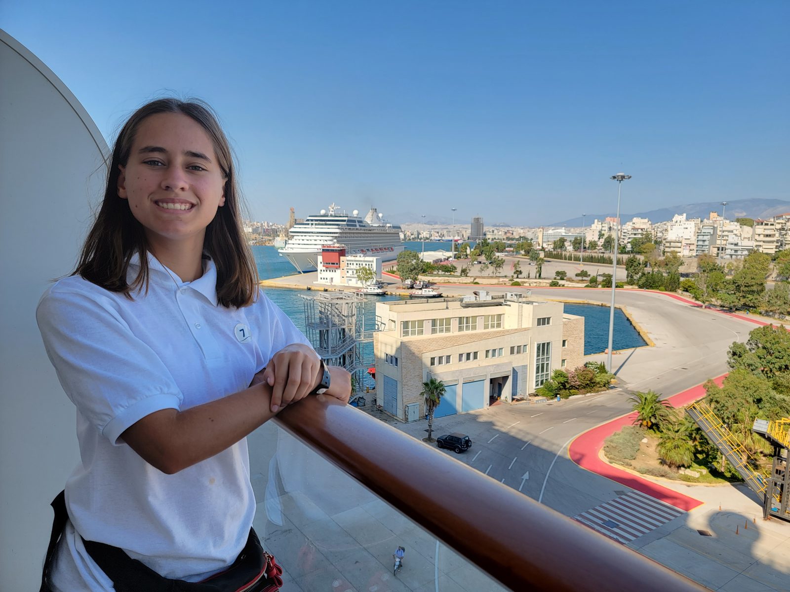 Lisa on the verandah with the port of Piraeus behind