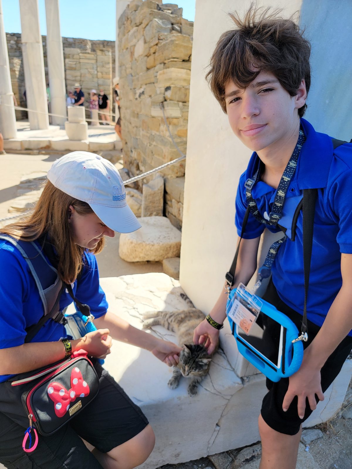 The kids making friends with a cat on Delos